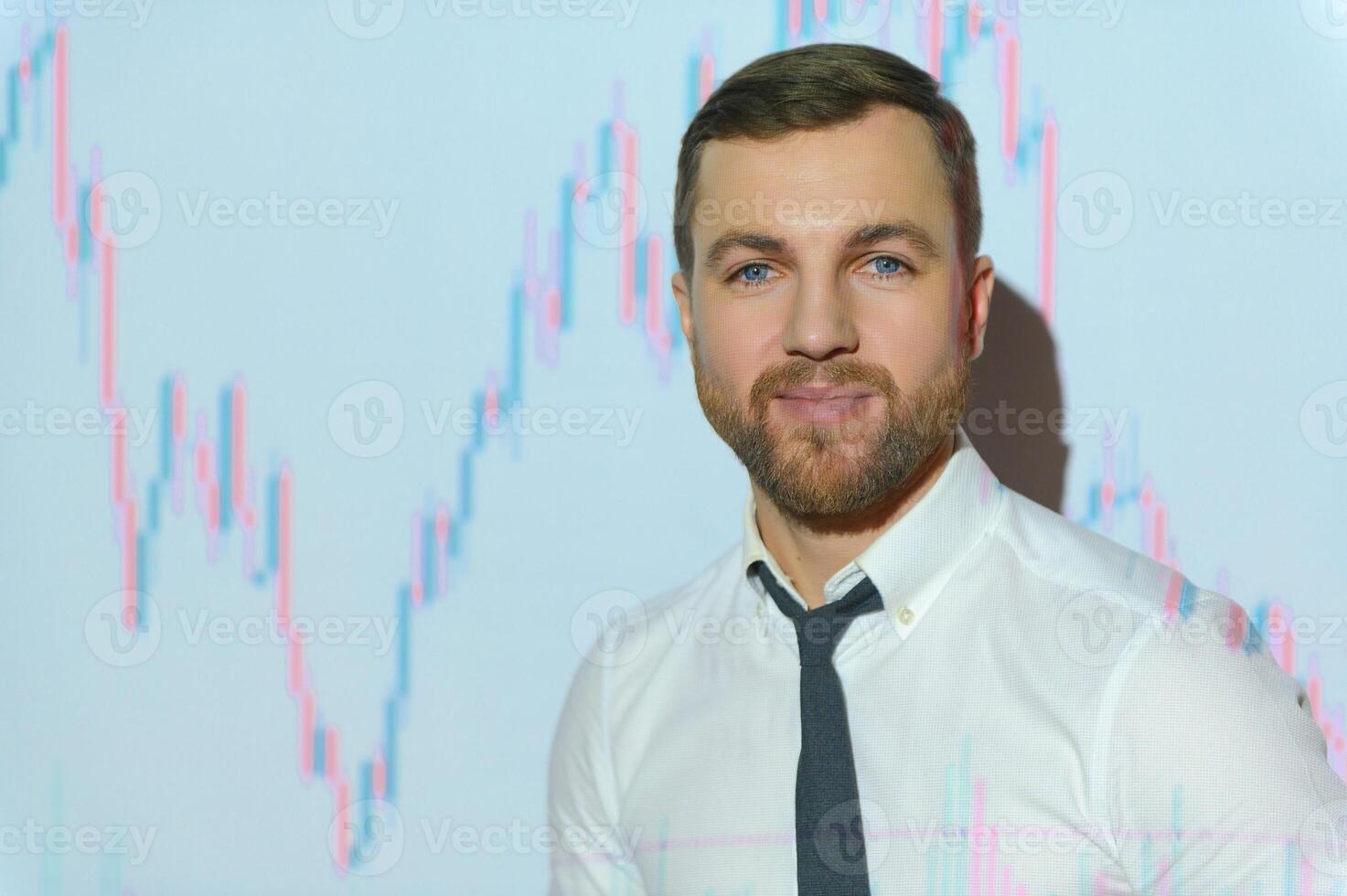Man is standing near projector and showing graphs and business graphs. photo
