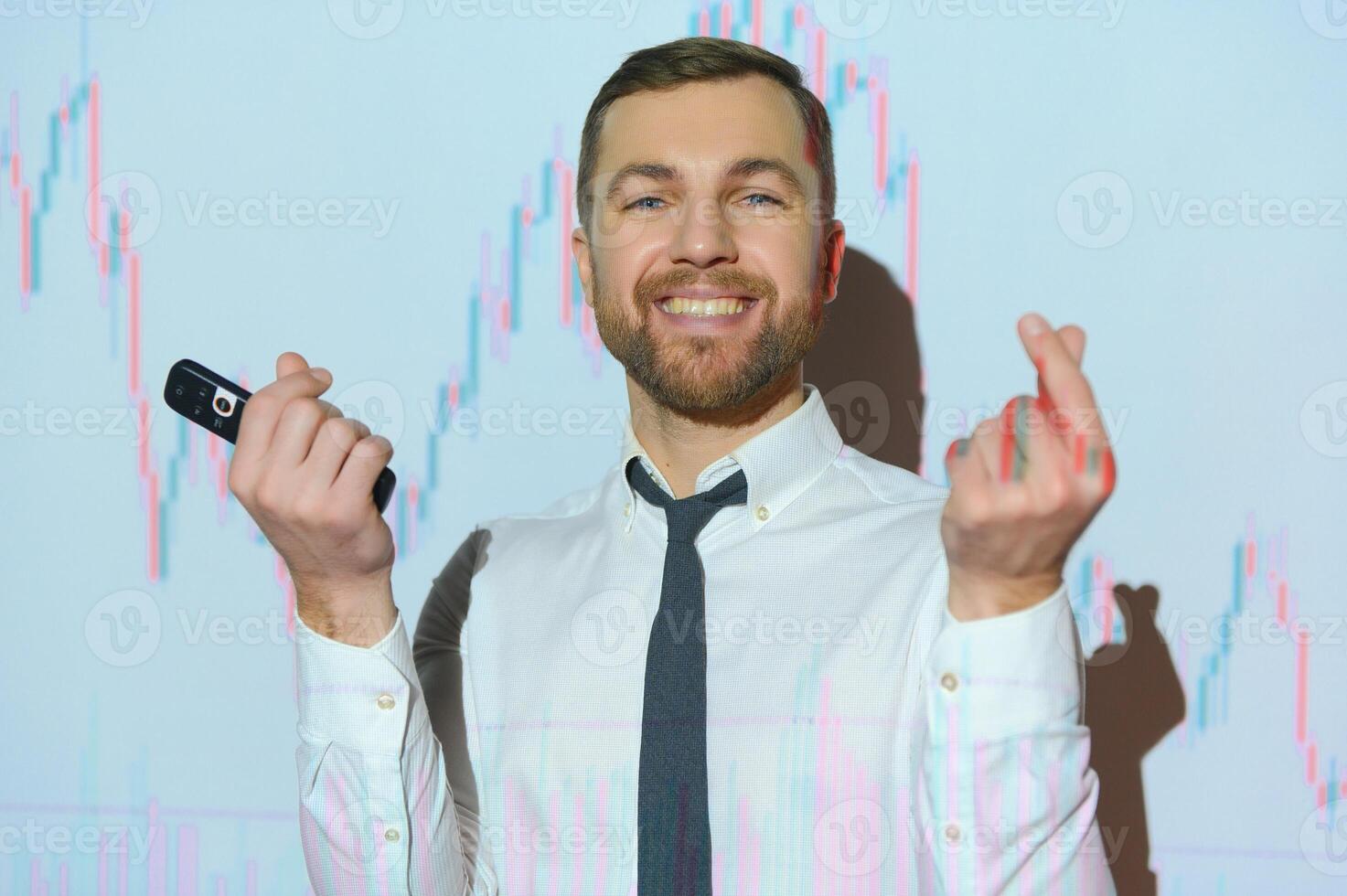Man is standing near projector and showing graphs and business graphs. photo