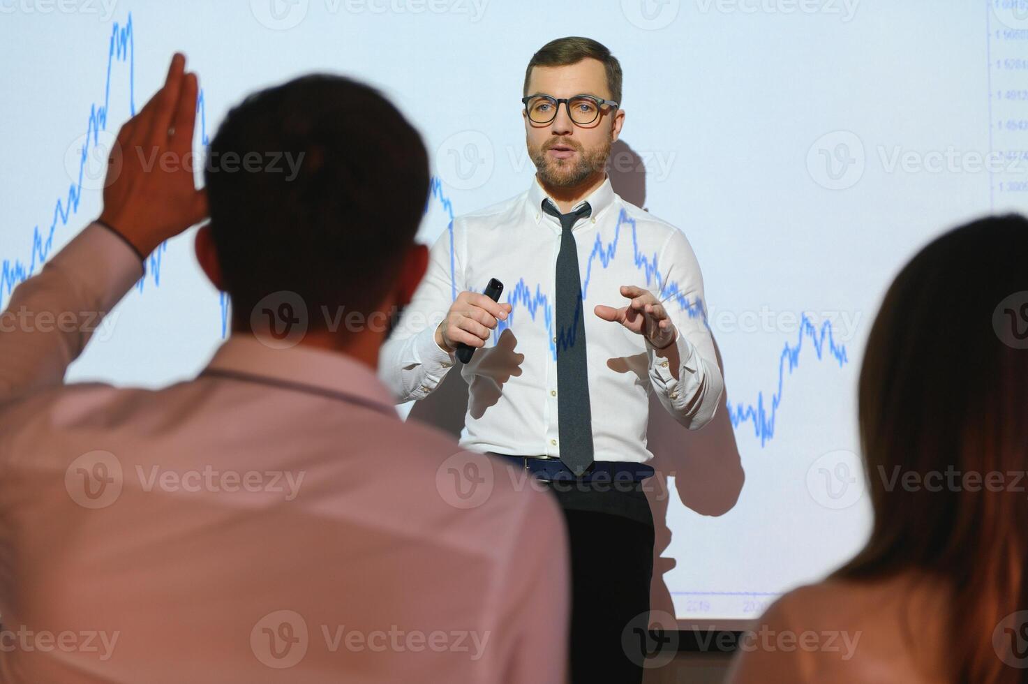 Happy speaker giving presentation in conference hall photo