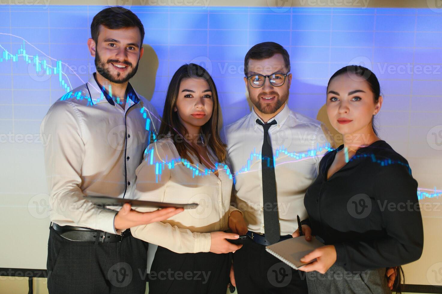 Group of business people working at modern office.Technical price graph, red and blue candlestick chart and stock trading computer screen background. Double exposure. Traders analyzing data photo