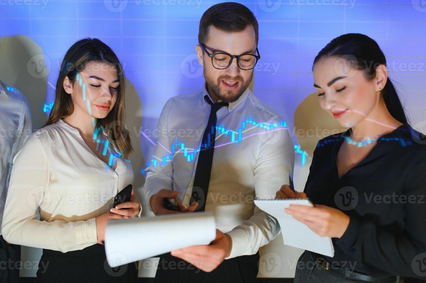 Group of business people working at modern office.Technical price graph, red and blue candlestick chart and stock trading computer screen background. Double exposure. Traders analyzing data photo