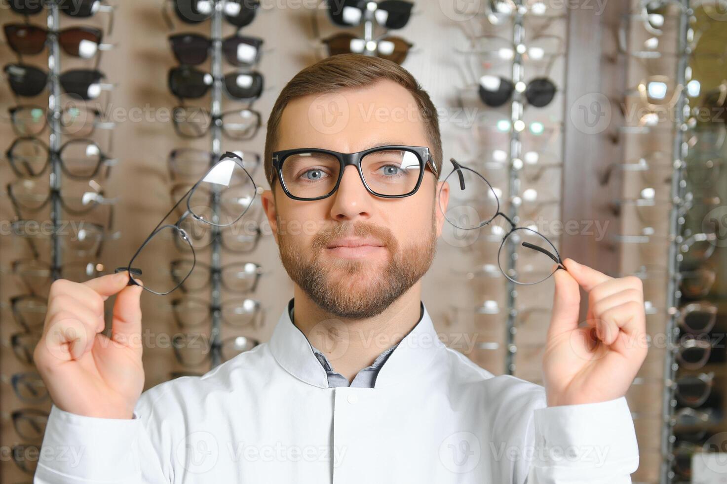 Close up of doctor oculist, optometrist holding, giving new eyeglasses photo
