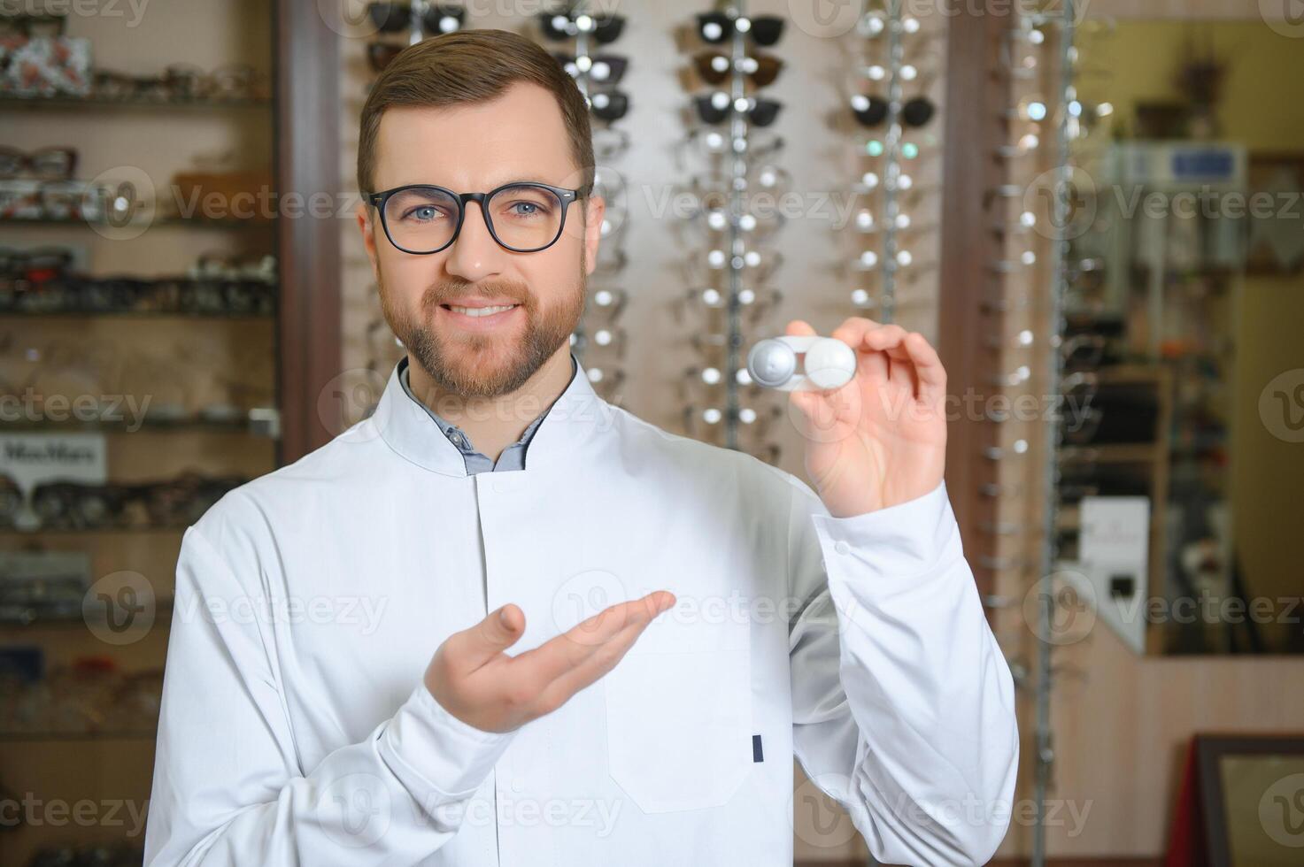 Doctor holds in his hand container with soft contact lenses for single use. Ophthalmologist prescribes use of one-day contact lenses for vision correction. Myopia and eyesight problem concept. photo