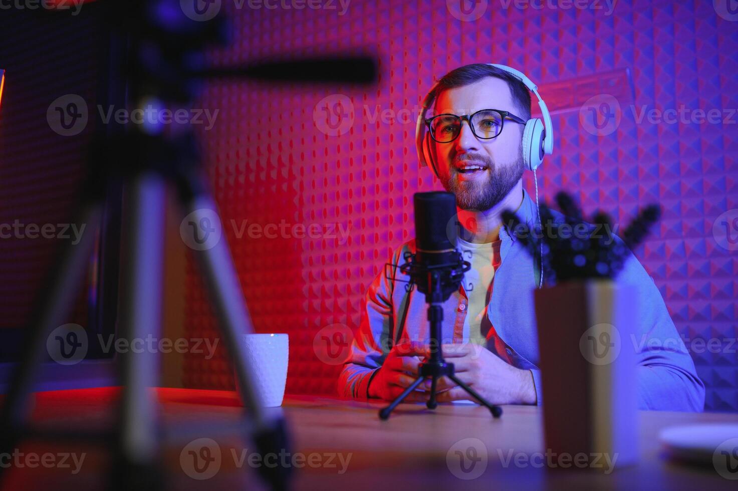 A blogger records content in his studio. The backstage photo was taken from behind one of the participants in the shooting, at the beginning of the shooting when the blogger is preparing.