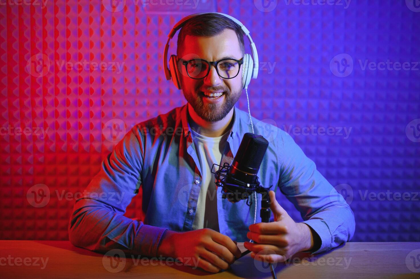 A blogger records content in his studio. The backstage photo was taken from behind one of the participants in the shooting, at the beginning of the shooting when the blogger is preparing.