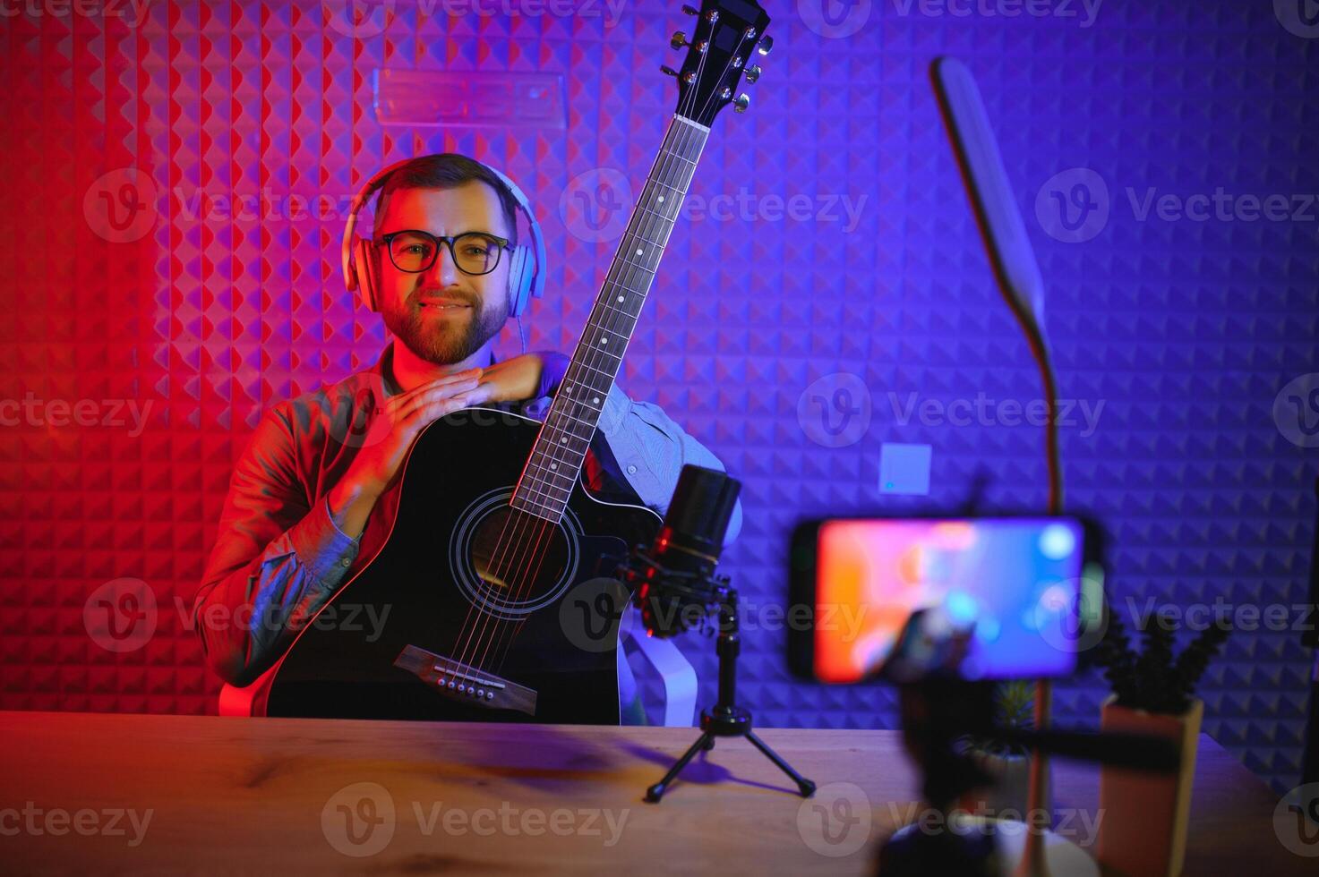 Male vlogger recording music related broadcast at studio photo