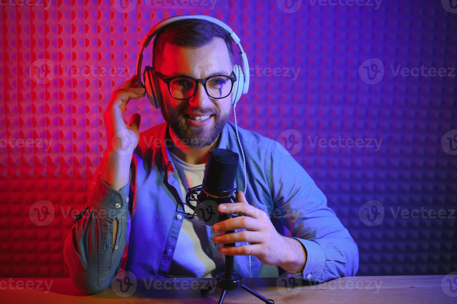 A blogger records content in his studio. The backstage photo was taken from behind one of the participants in the shooting, at the beginning of the shooting when the blogger is preparing.