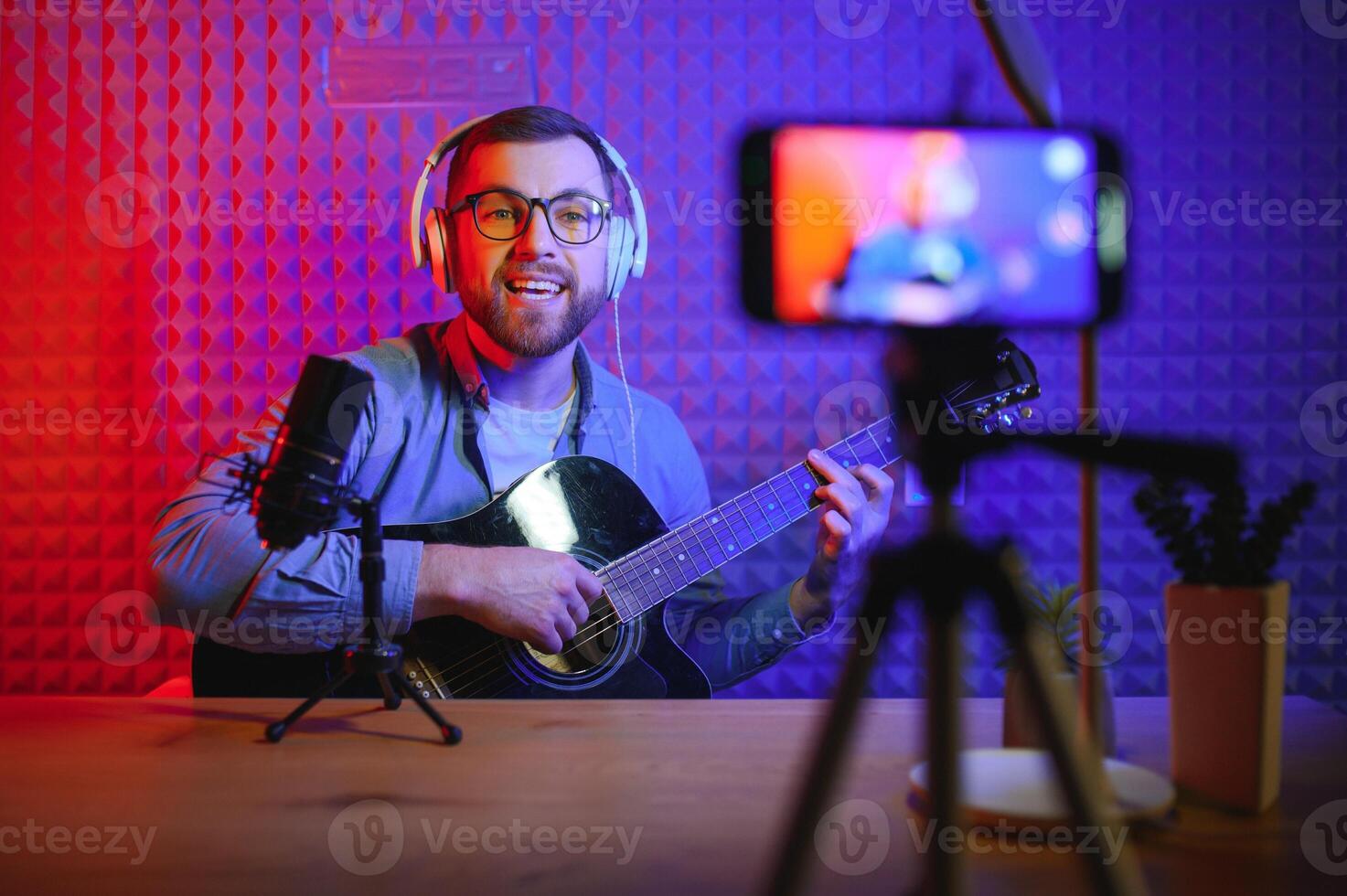 Male vlogger recording music related broadcast at studio photo