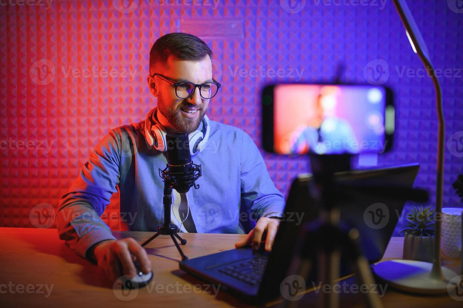 A blogger records content in his studio. The backstage photo was taken from behind one of the participants in the shooting, at the beginning of the shooting when the blogger is preparing.