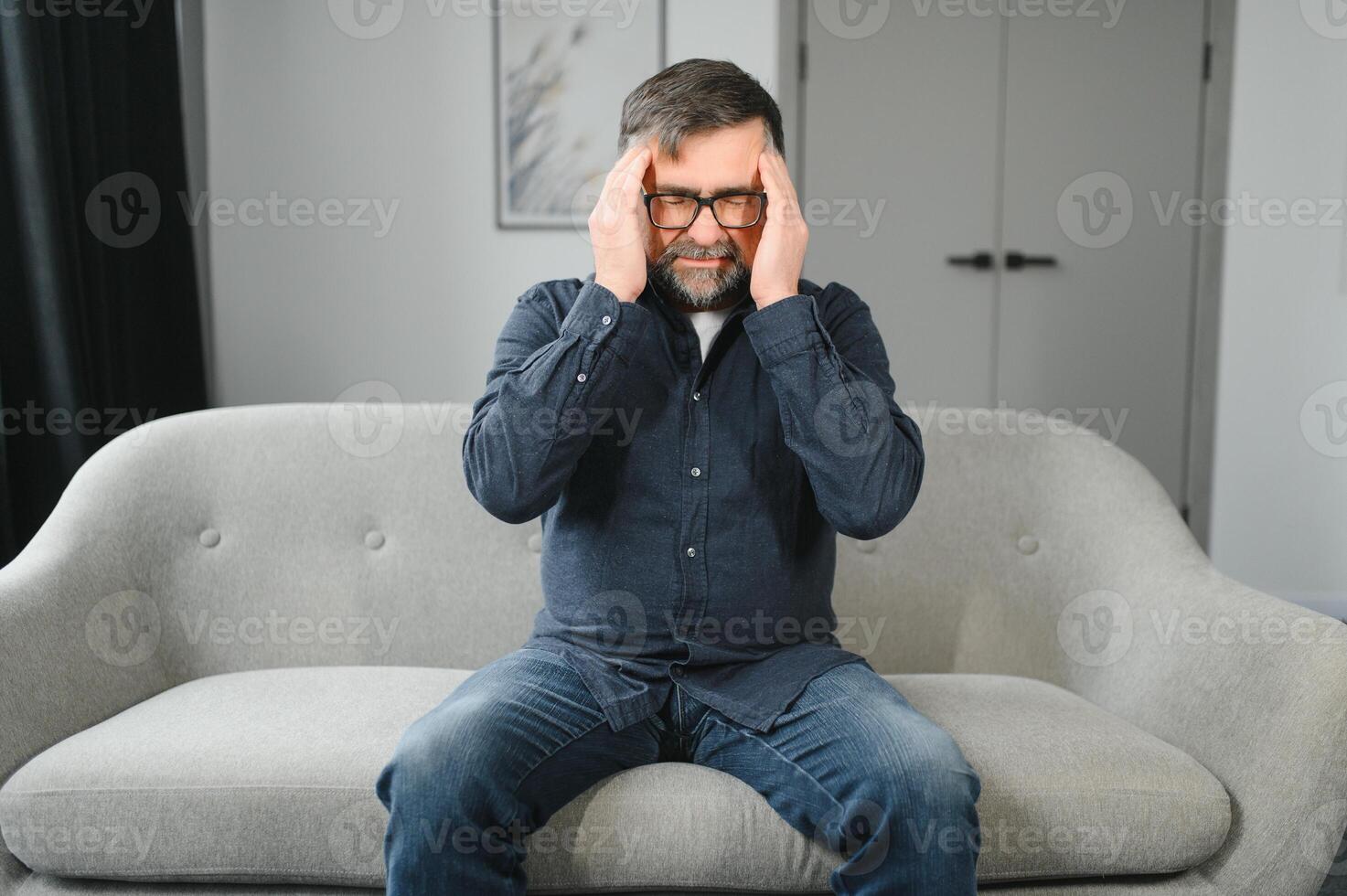 Headache. Senior Man Suffering From Migraine Pain Massaging Temples Sitting At Home. Healthcare, Health Problems In Older Age Concept photo