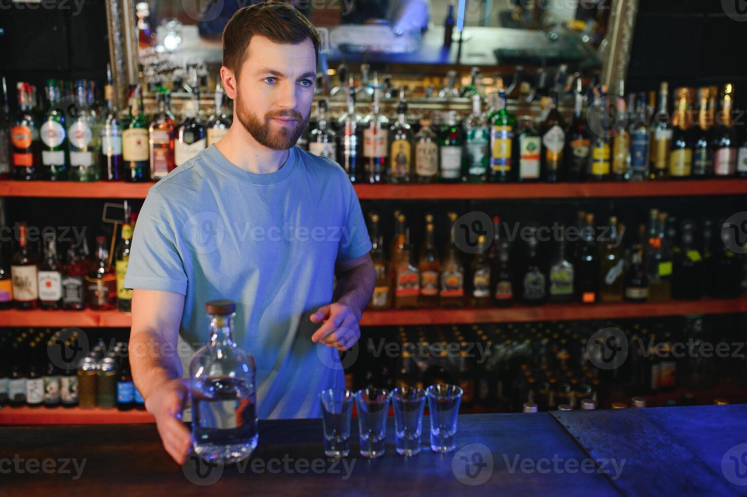 Portrait Of Smiling Male Bar Owner Standing Behind Counter photo