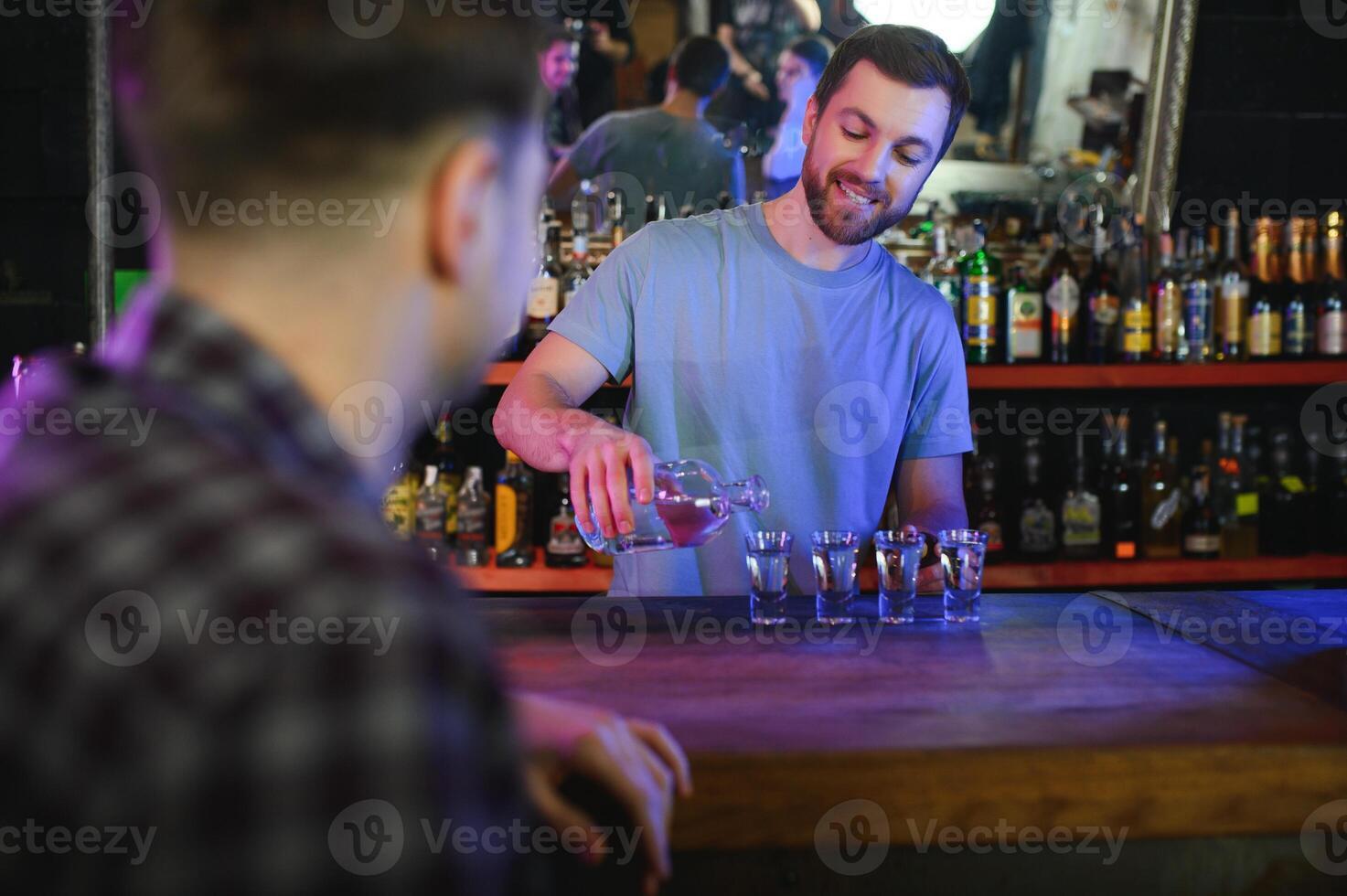 Portrait Of Smiling Male Bar Owner Standing Behind Counter photo