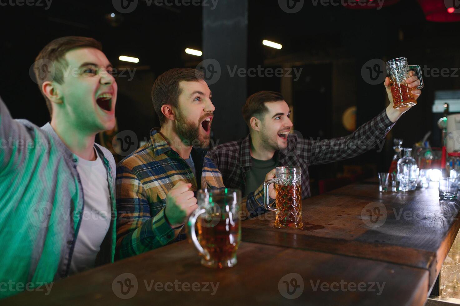Sport, people, leisure, friendship, entertainment concept - happy male football fans or good yuong friends drinking beer, celebrating victory at bar or pub. Human positive emotions concept photo