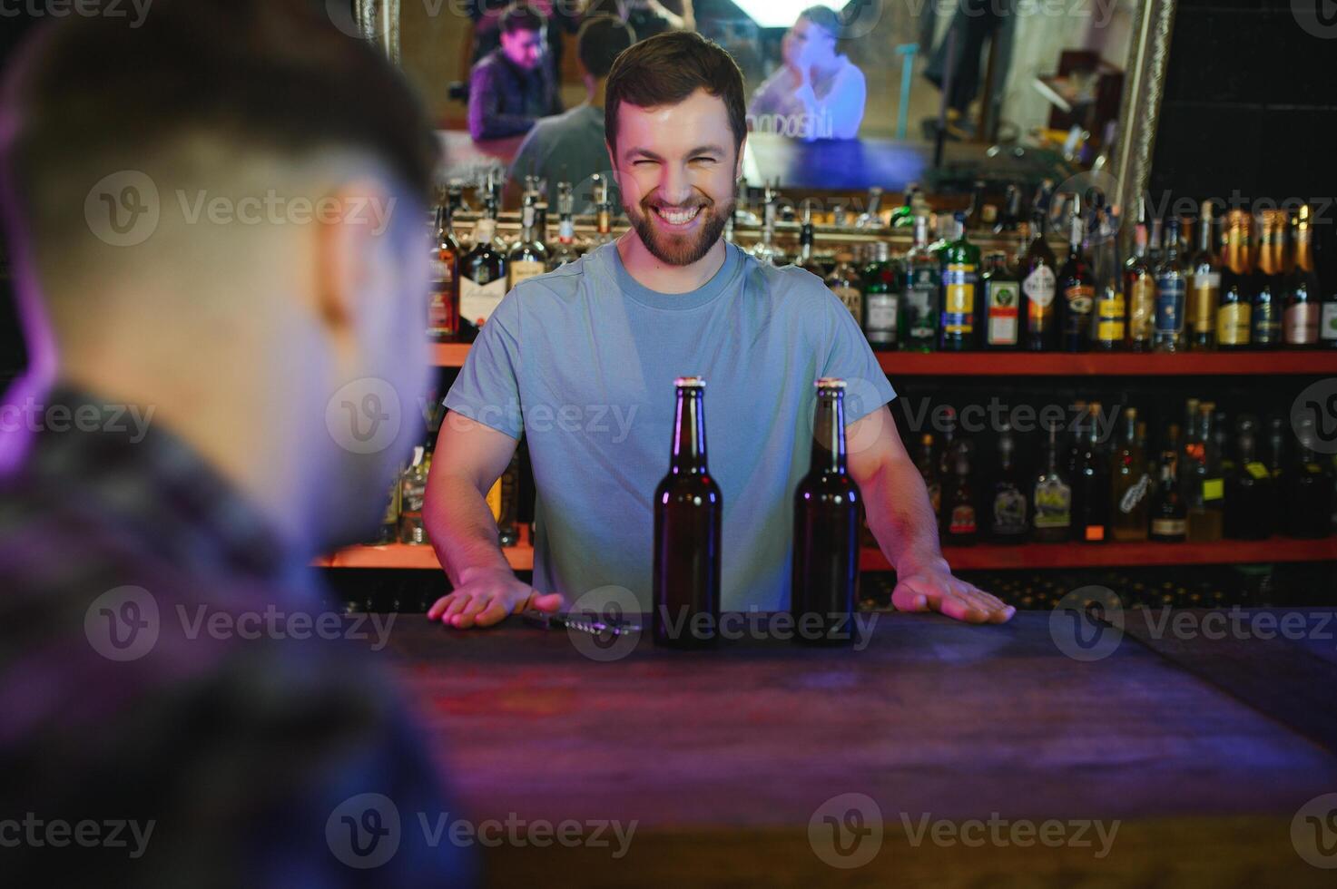 Portrait Of Smiling Male Bar Owner Standing Behind Counter photo
