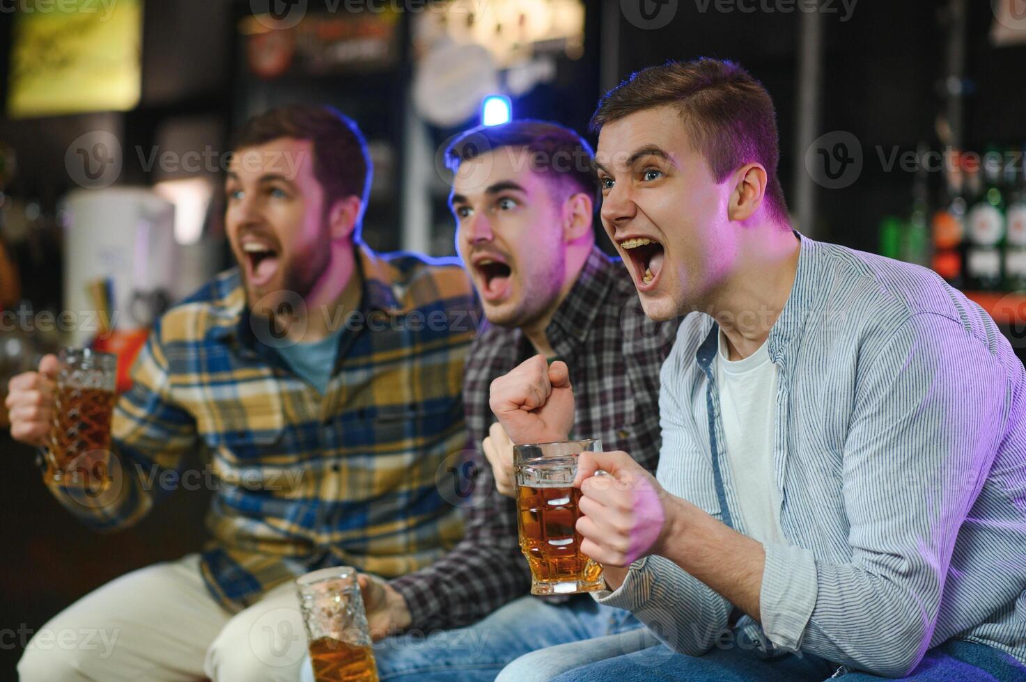 Sport, people, leisure, friendship, entertainment concept - happy male football fans or good yuong friends drinking beer, celebrating victory at bar or pub. Human positive emotions concept photo