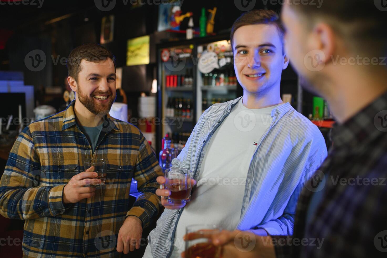 Conception of nightlife. People have fun in the club. With alcohol in hands. photo