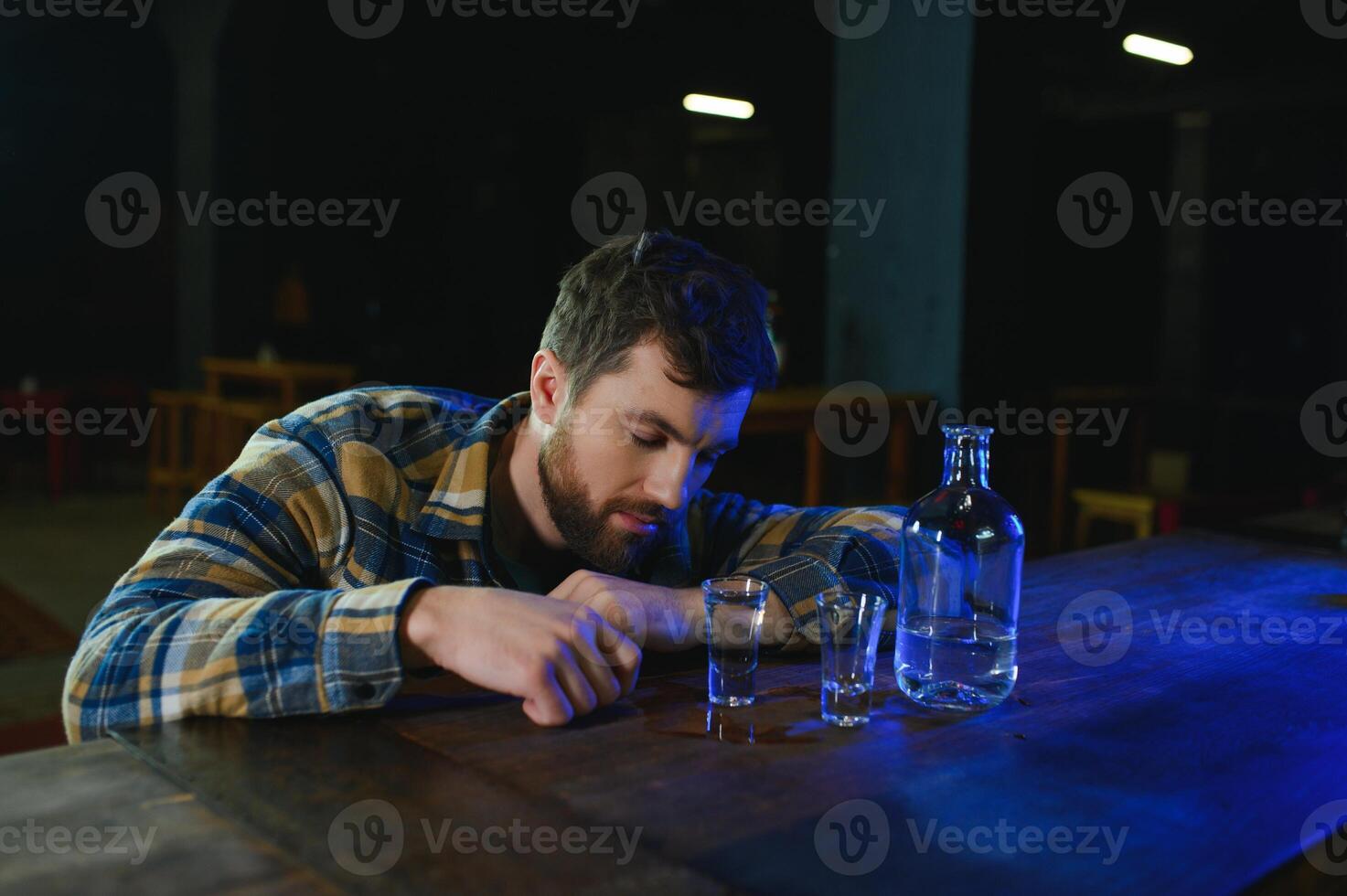 Sad man sitting at bar counter, alcohol addiction photo