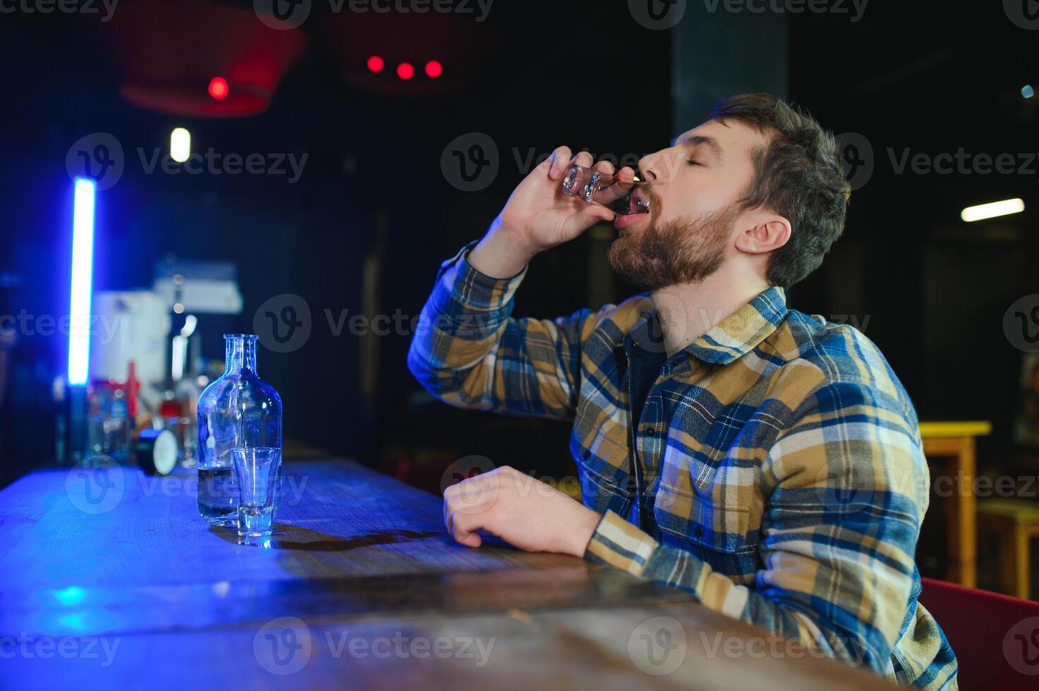 Sad man sitting at bar counter, alcohol addiction photo