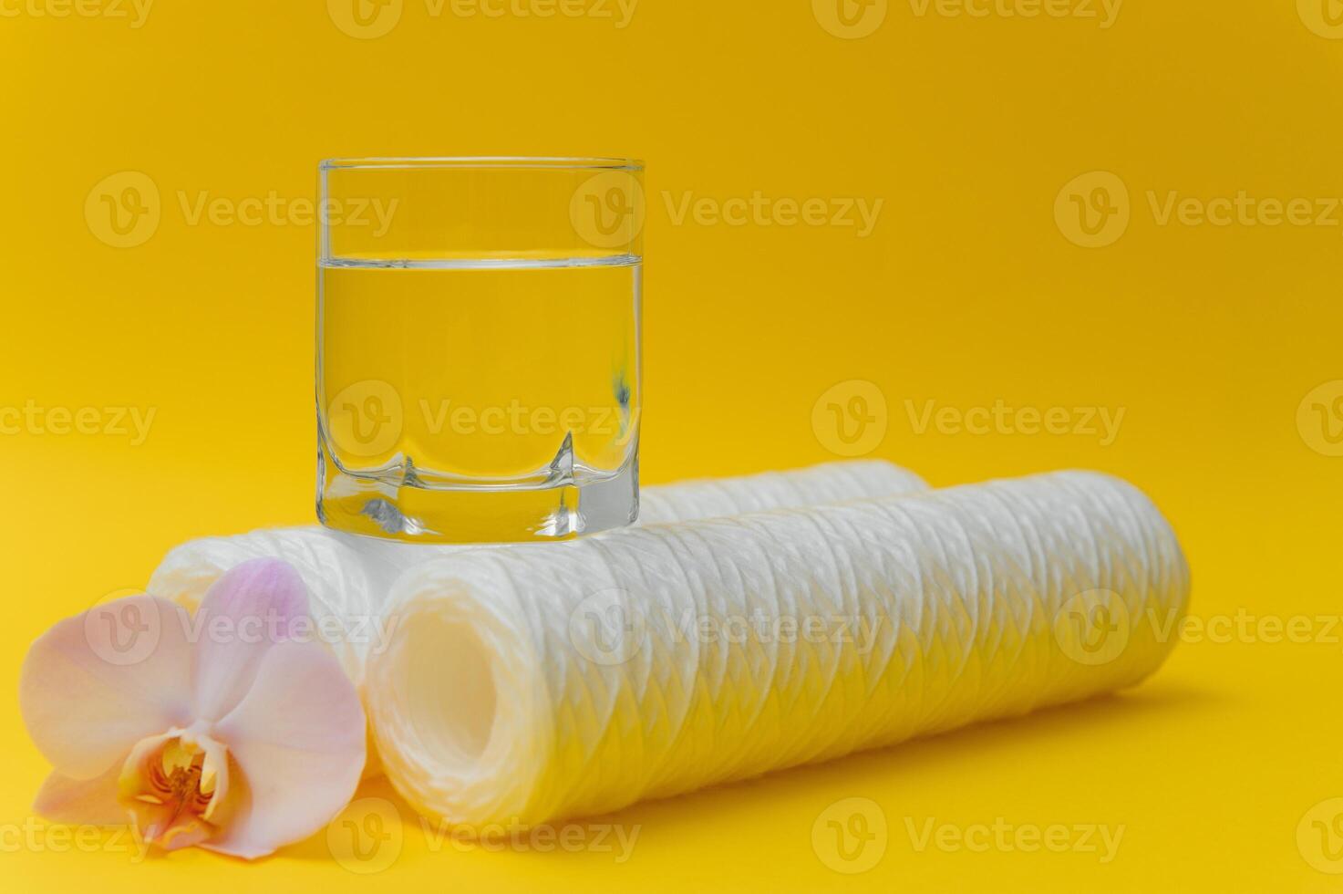cartridges for water purification on a yellow background. Concept of clean water at home photo