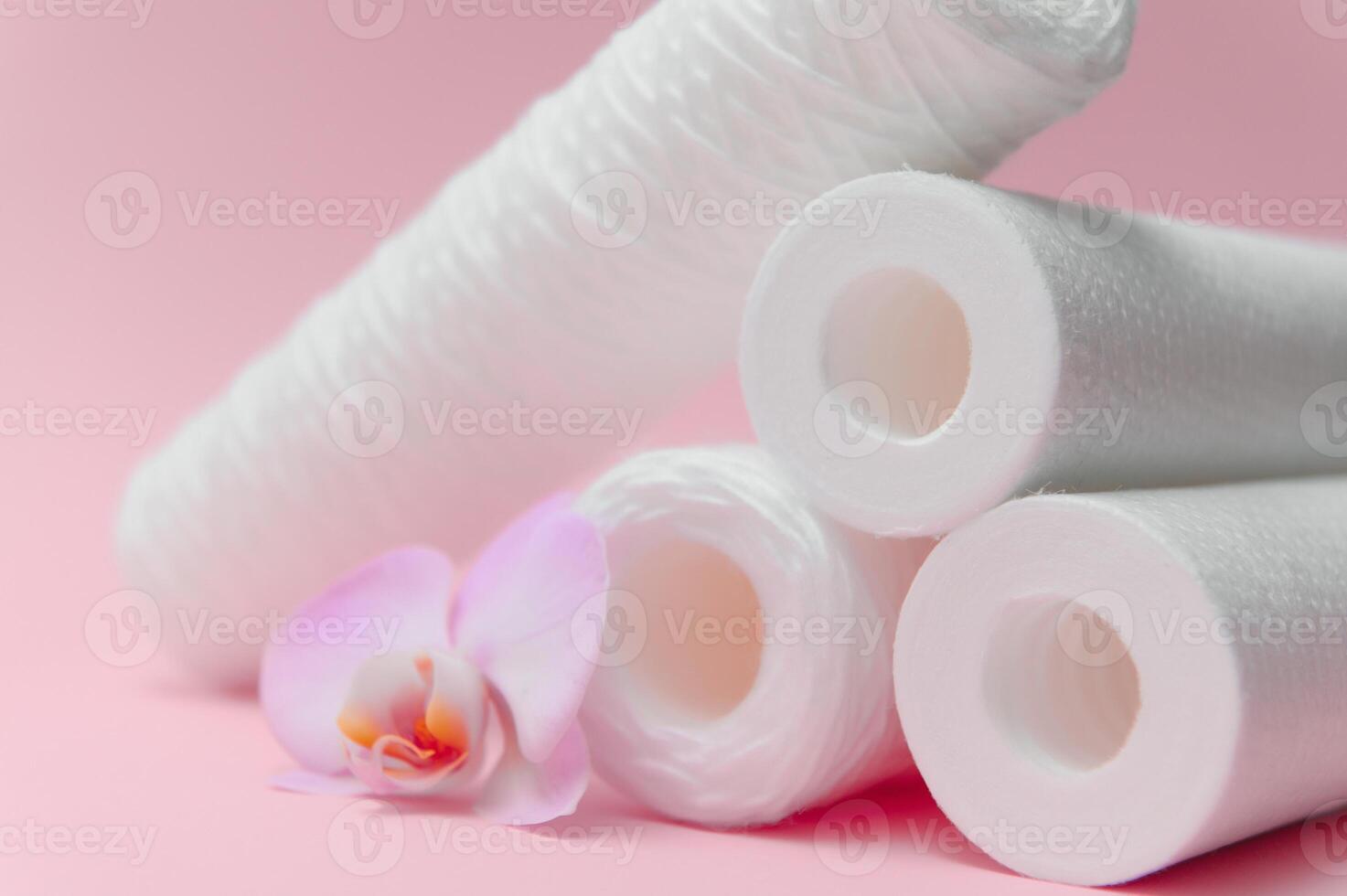 filter cartridges for water on a pink background. Installation of reverse osmosis water purification system. photo