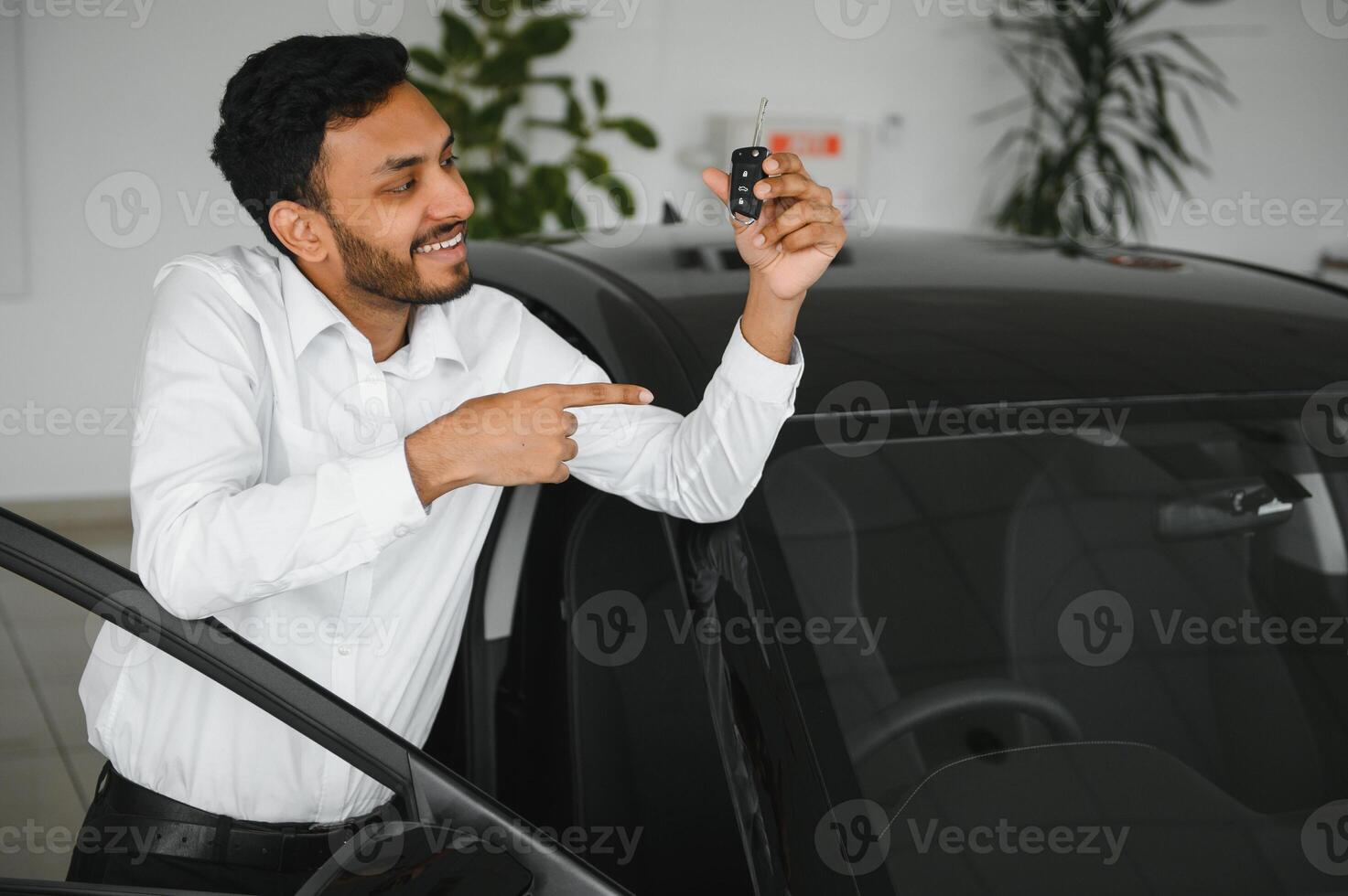 Closeup portrait happy, smiling, young man, buyer showing keys of his new car photo