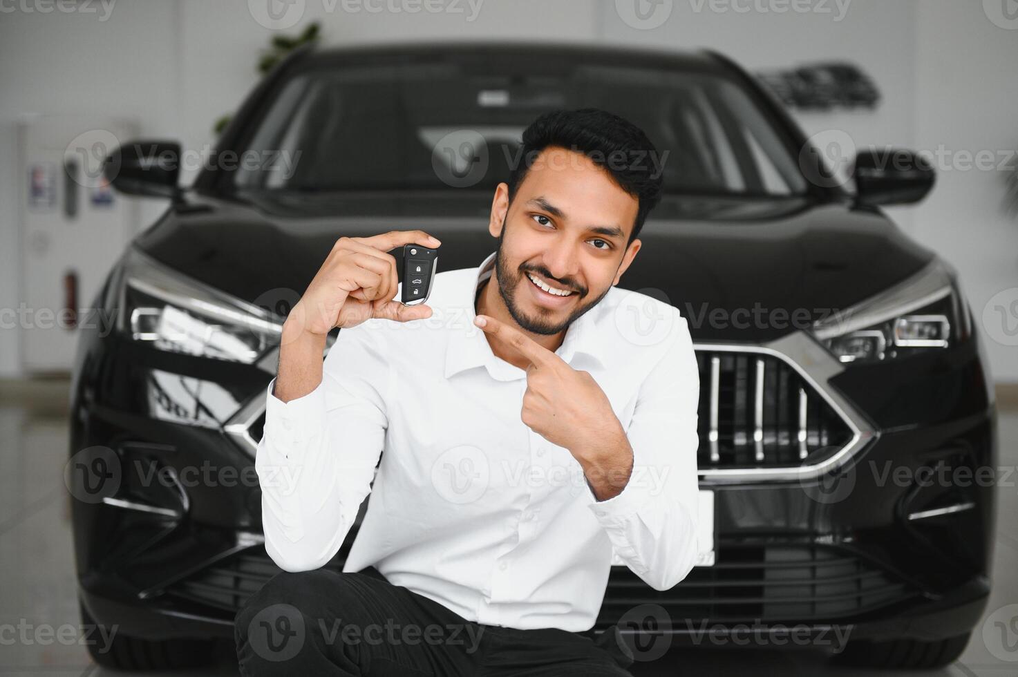 Closeup portrait happy, smiling, young man, buyer showing keys of his new car photo