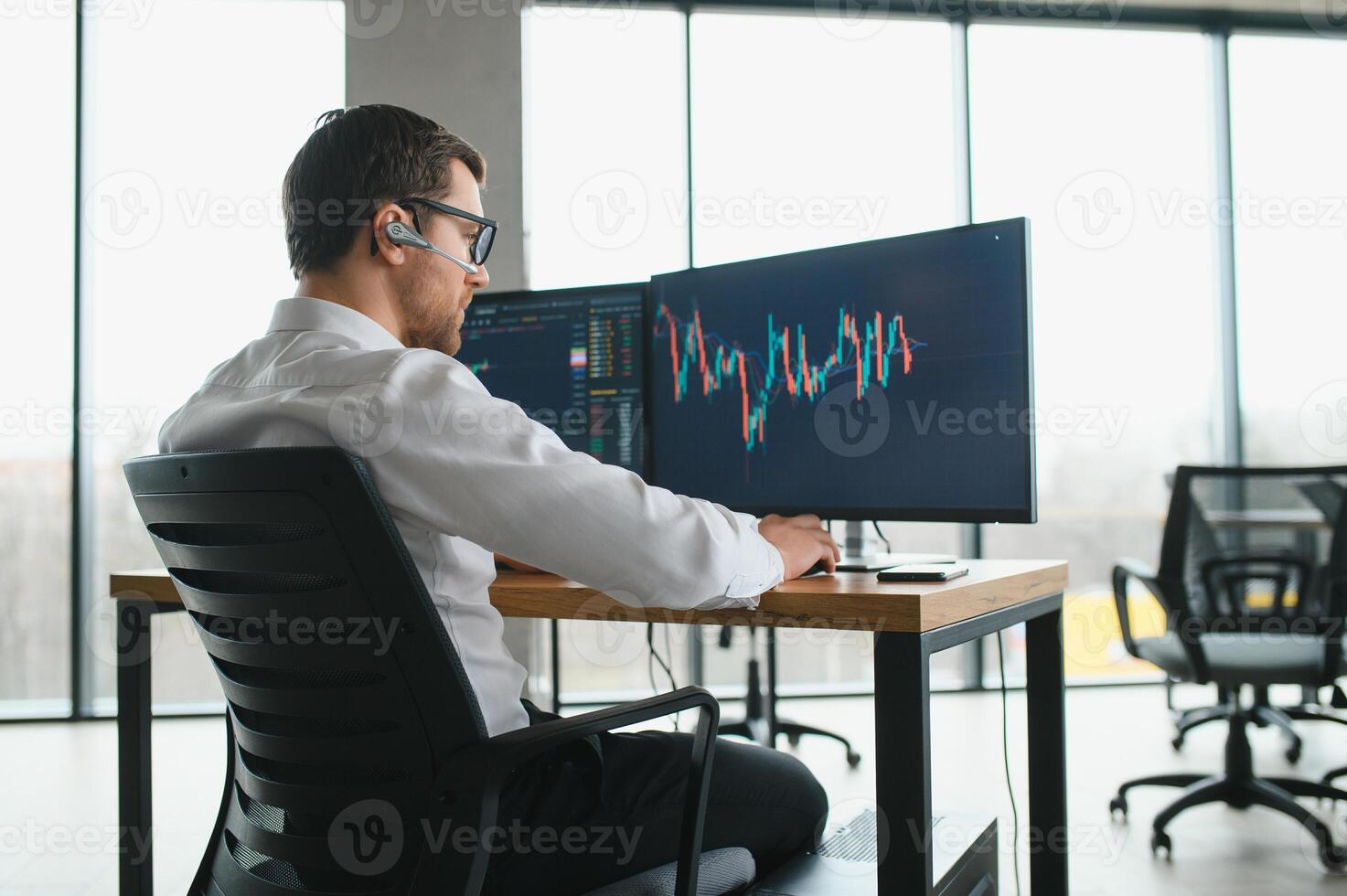 Successful trader in formalwear checking cryptocurrency information data on finance market graph, working in office photo