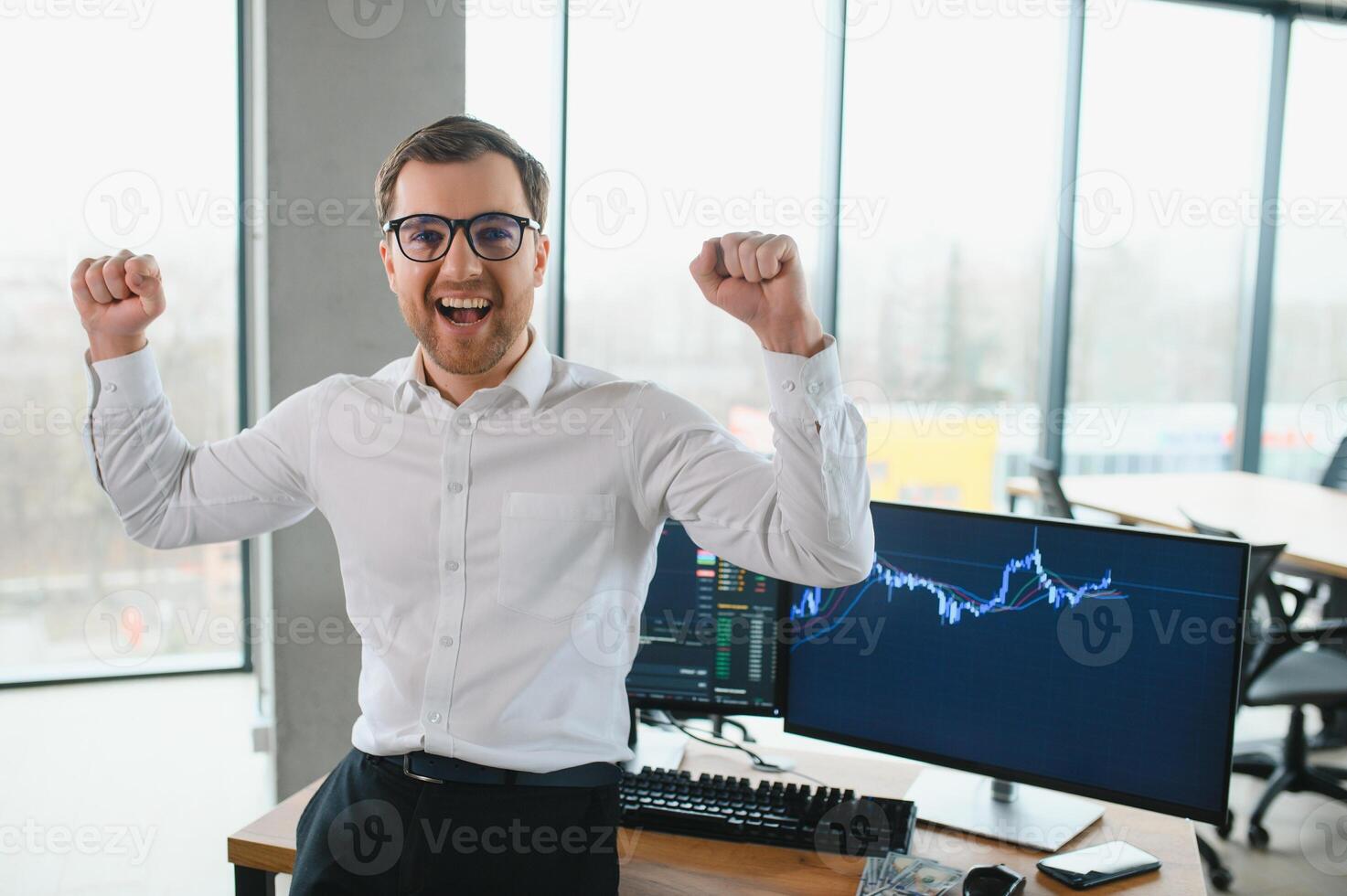 Young bearded man trader at office at table looking camera smiling cheerful photo