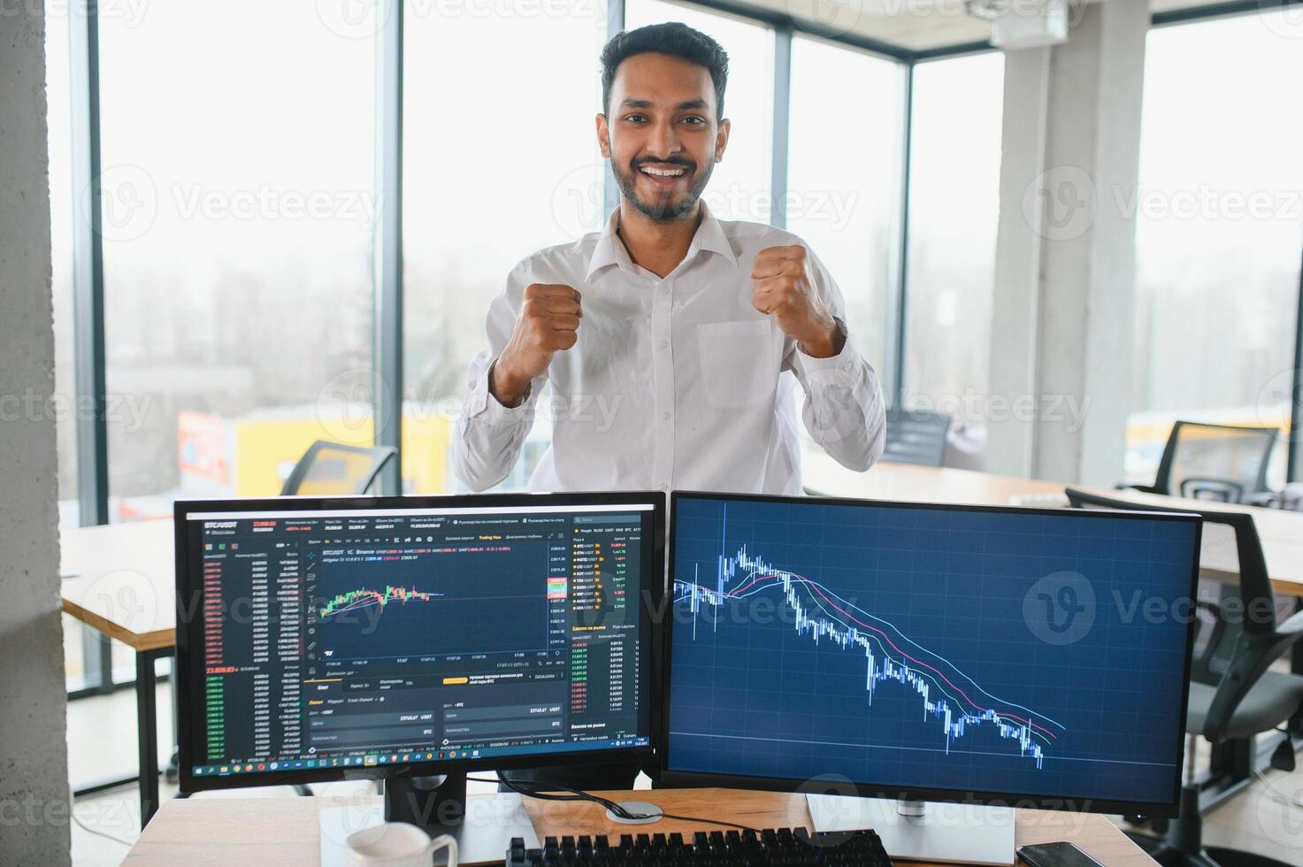 Young indian business man trader looking at computer screen with trading charts reflecting in eyeglasses watching stock trading market financial data growth concept, close up. photo