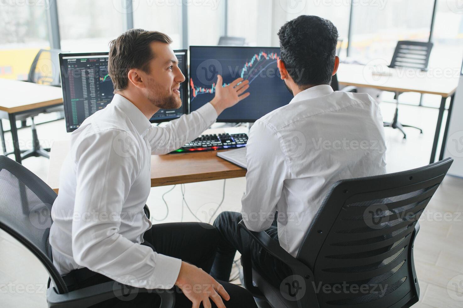 Two diverse crypto traders brokers stock exchange market investors discussing trading charts research reports growth using pc computer looking at screen analyzing invest strategy, financial risks. photo