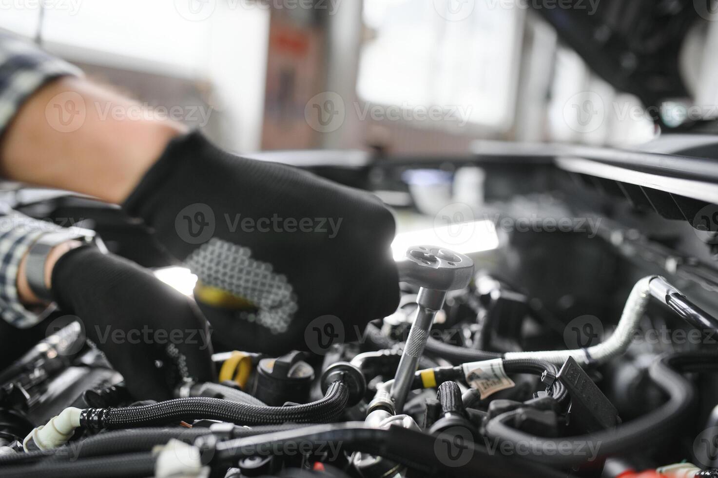 Professional Mechanic is Working on a Car in a Car Service. photo