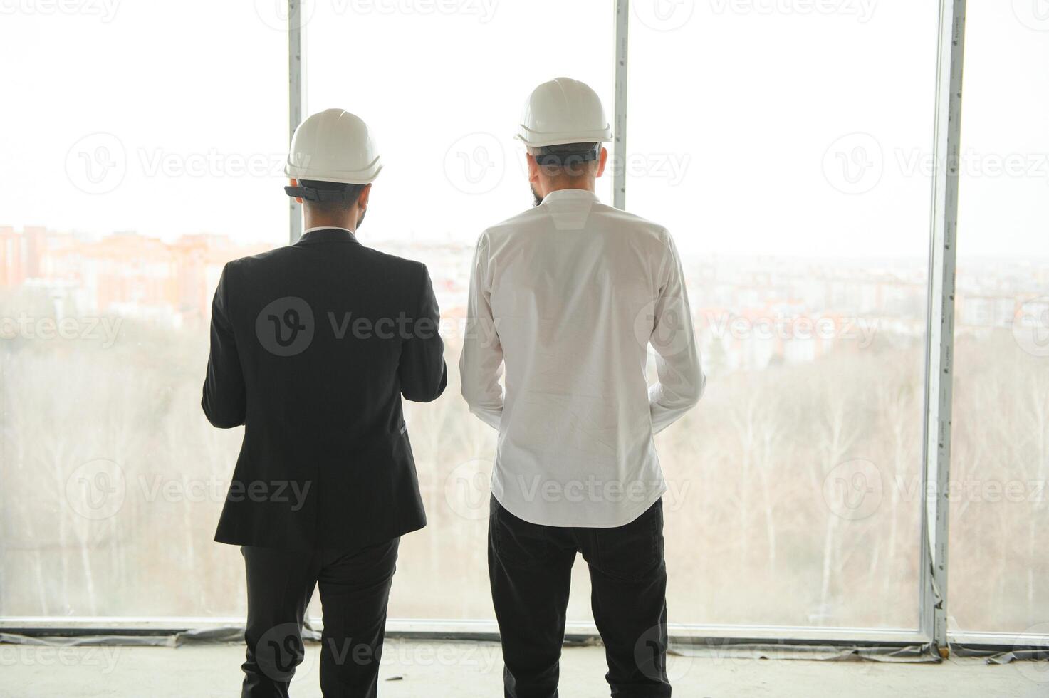 Construction concept of multiracial Engineer and Architect working at Construction Site with blue print photo