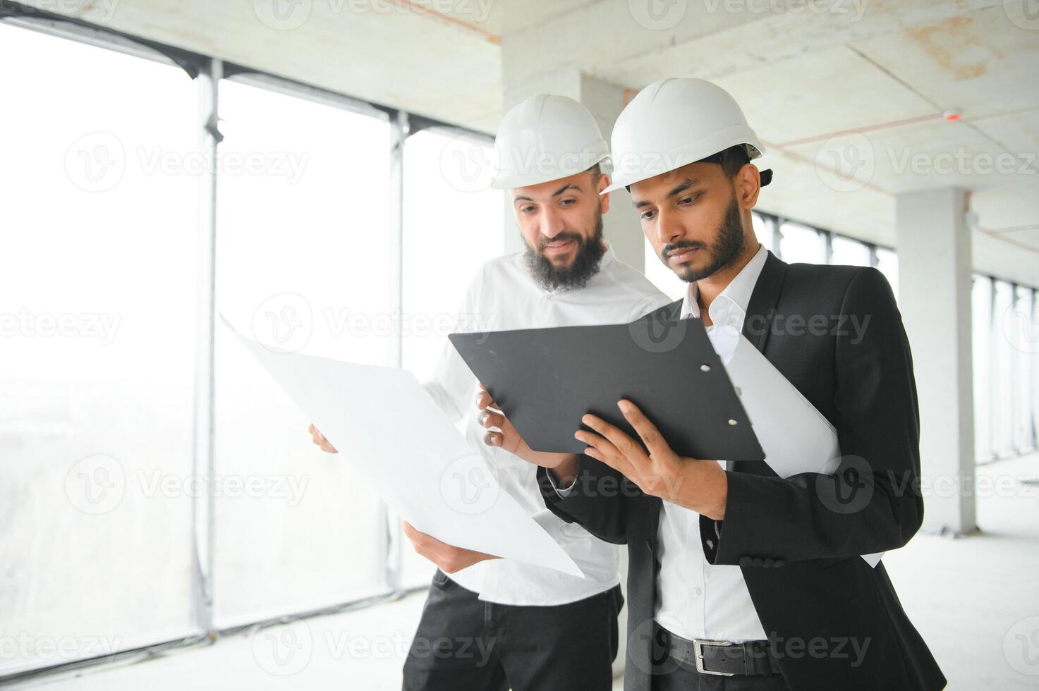 Construction concept of multiracial Engineer and Architect working at Construction Site with blue print photo