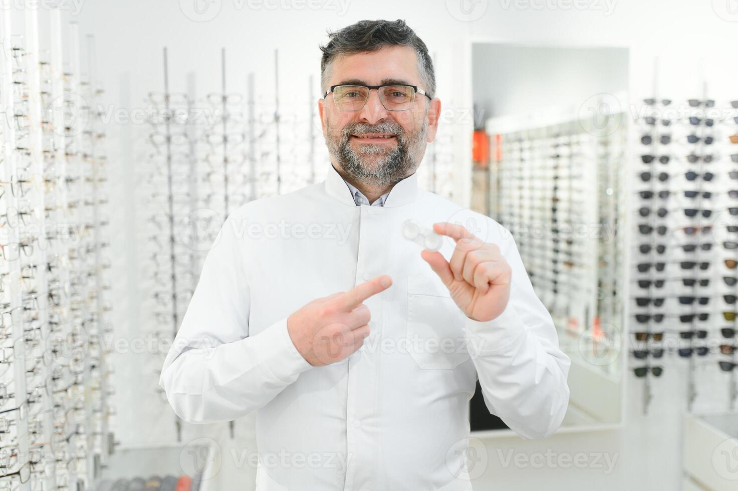 Doctor holds in his hand container with soft contact lenses for single use. Ophthalmologist prescribes use of one-day contact lenses for vision correction. Myopia and eyesight problem concept. photo