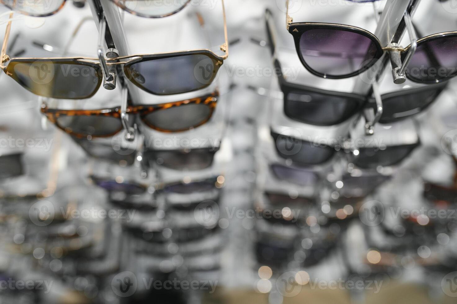 Sunglasses on display shelves in glasses store photo