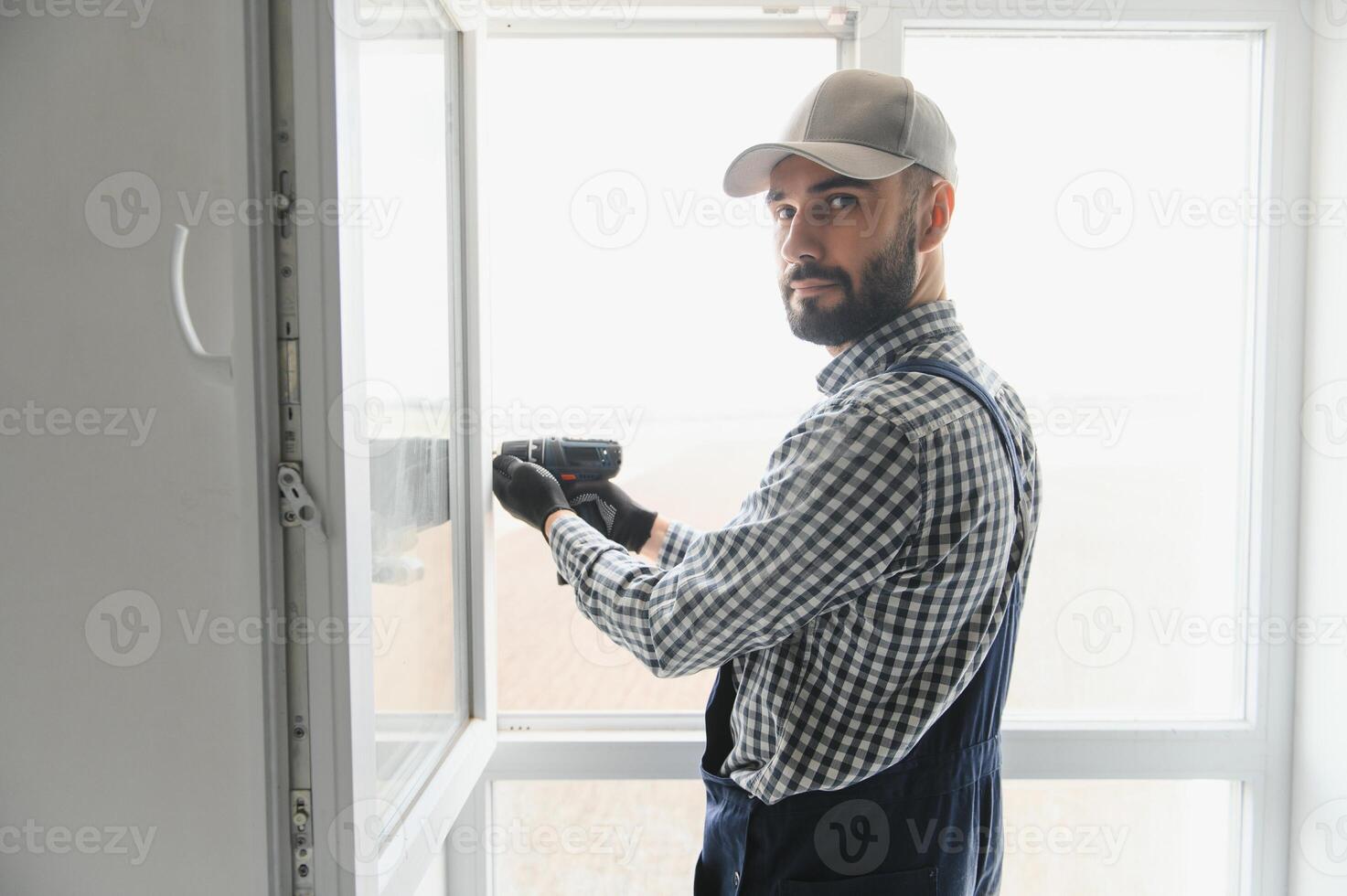 Construction worker installing window in house photo
