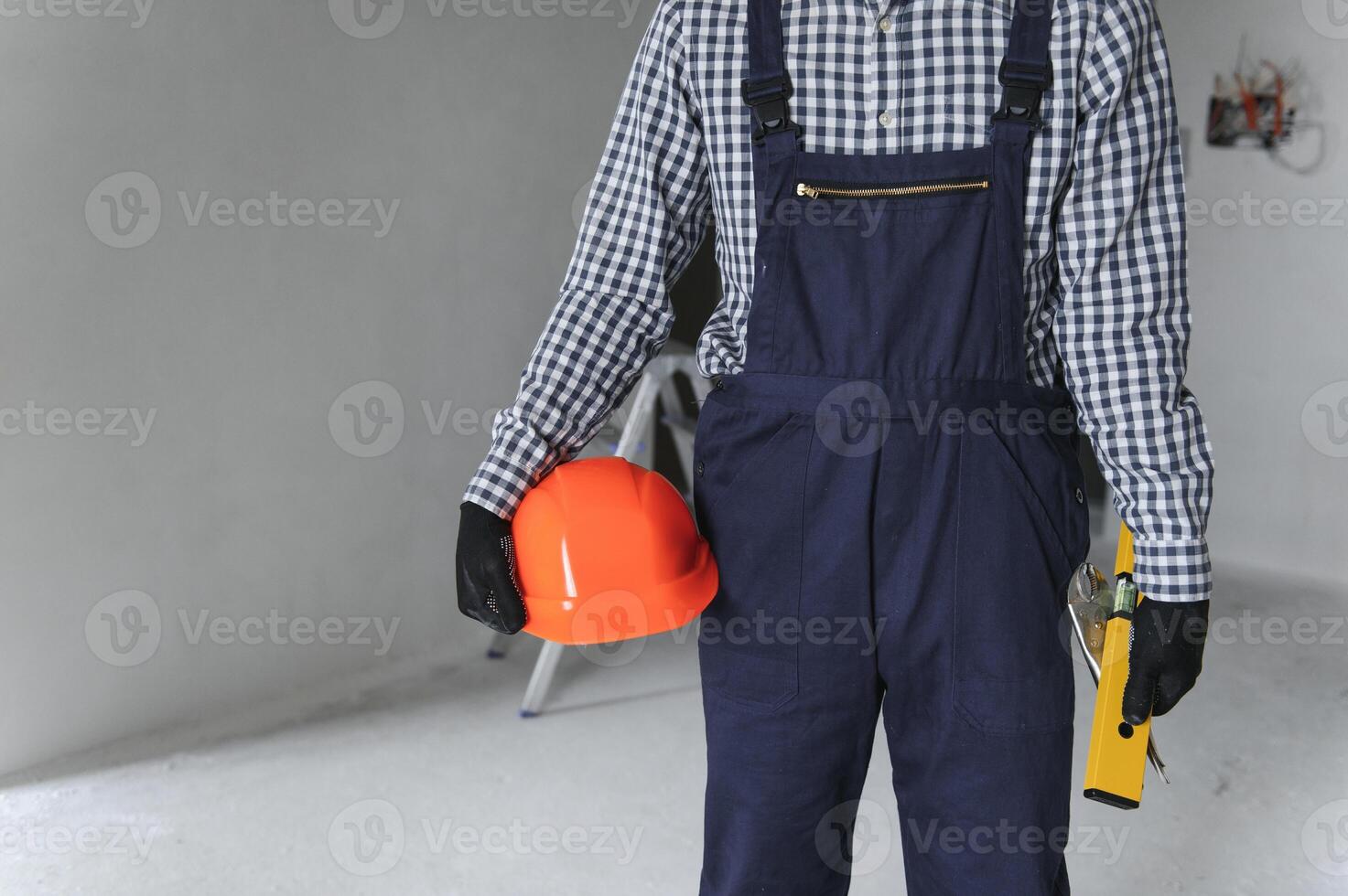 Builder handyman with construction tools. House renovation background. photo