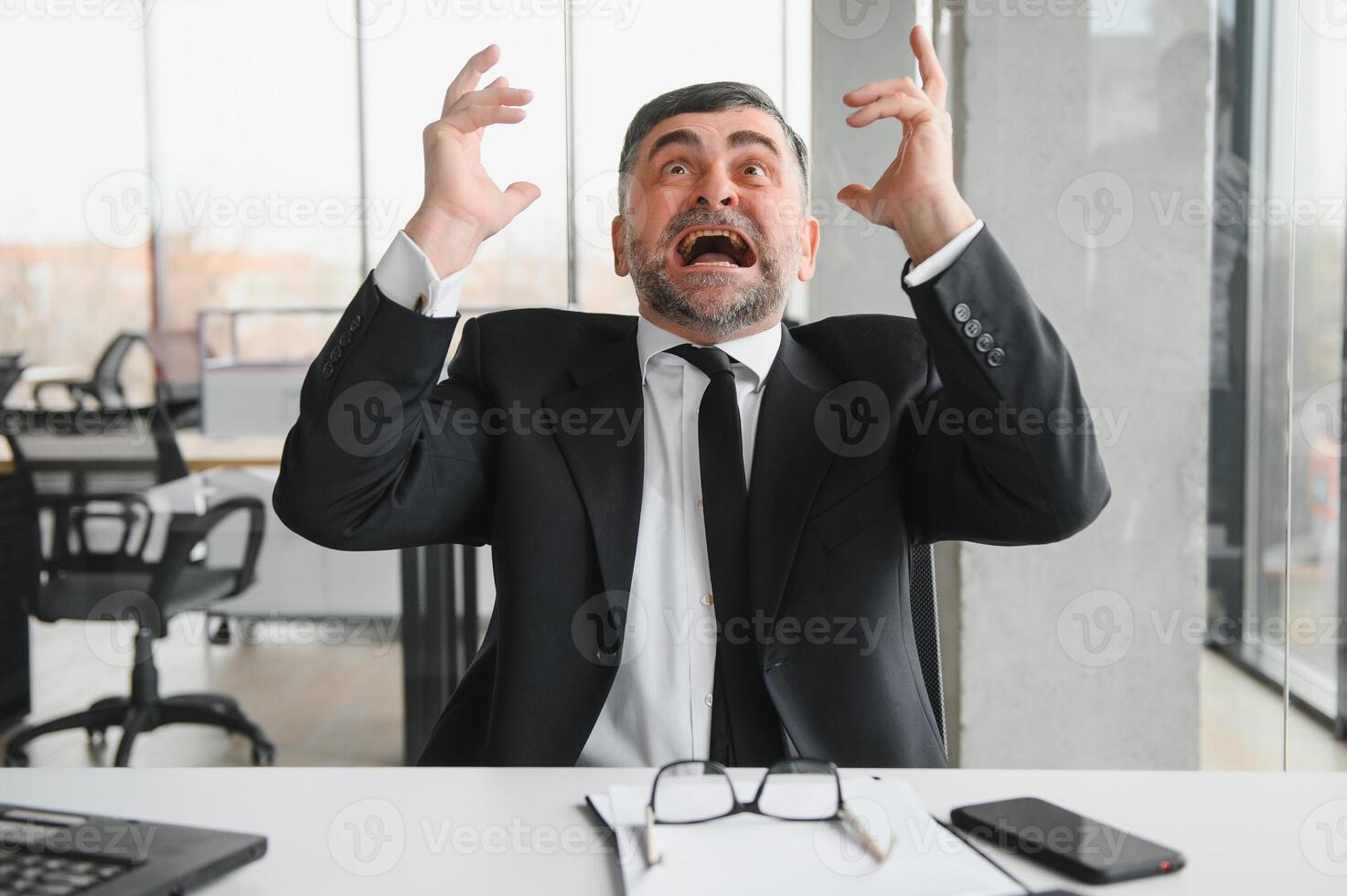 Angry businessman with document shouting at somebody photo