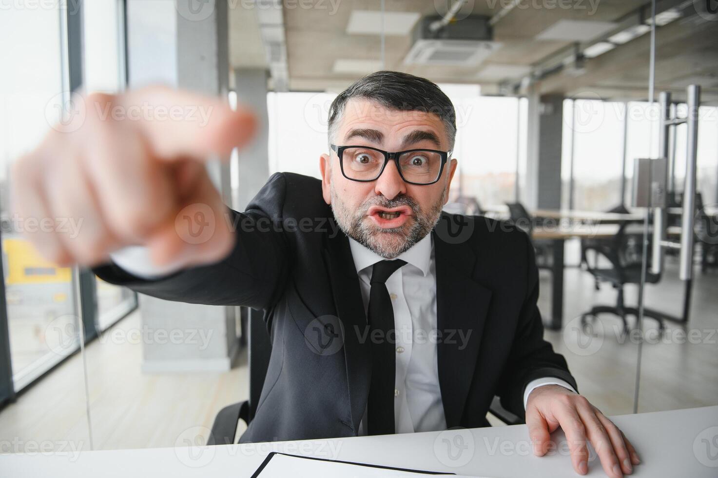 Angry boss shouting at his employee photo