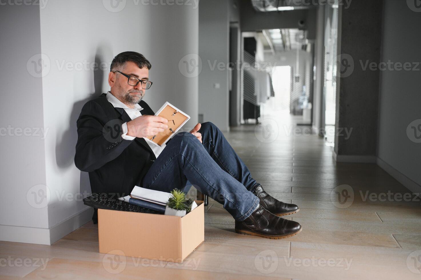Old male employee being fired from his work photo