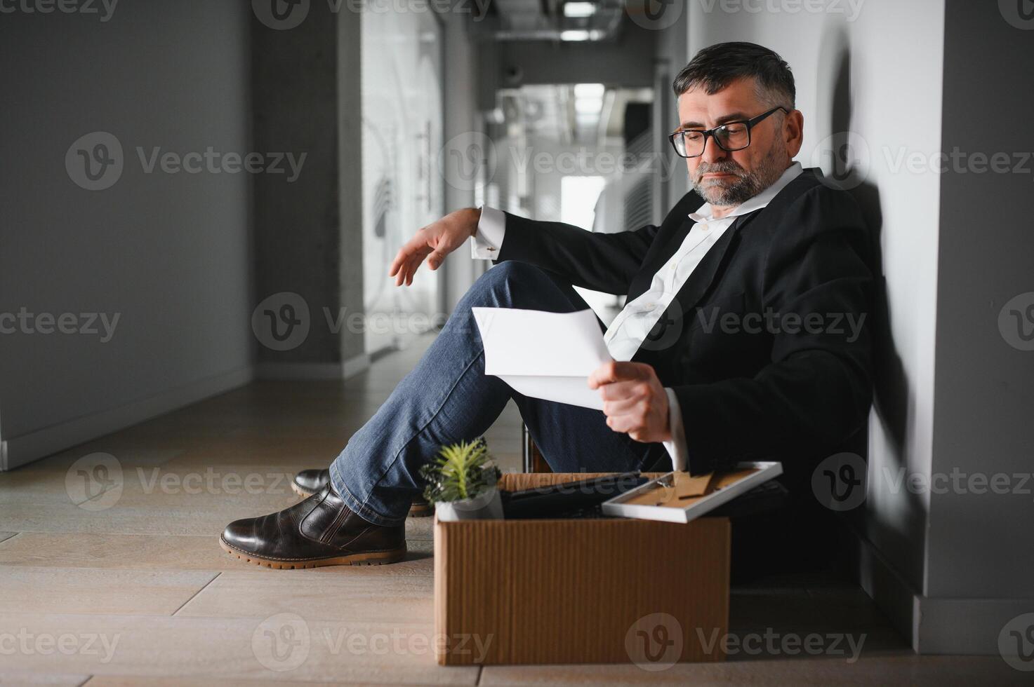 Portrait of sad dismissed senior old business man worker taking his office supplies in the box. Pensioner mature retire from work carry staff back home. Lifestyle business retirement, quit job concept photo