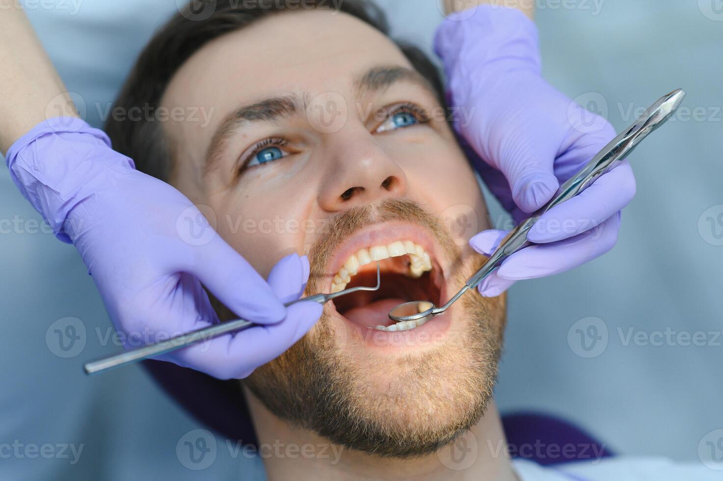 Dental care concept. Handsome young guy at the dentist's office. photo