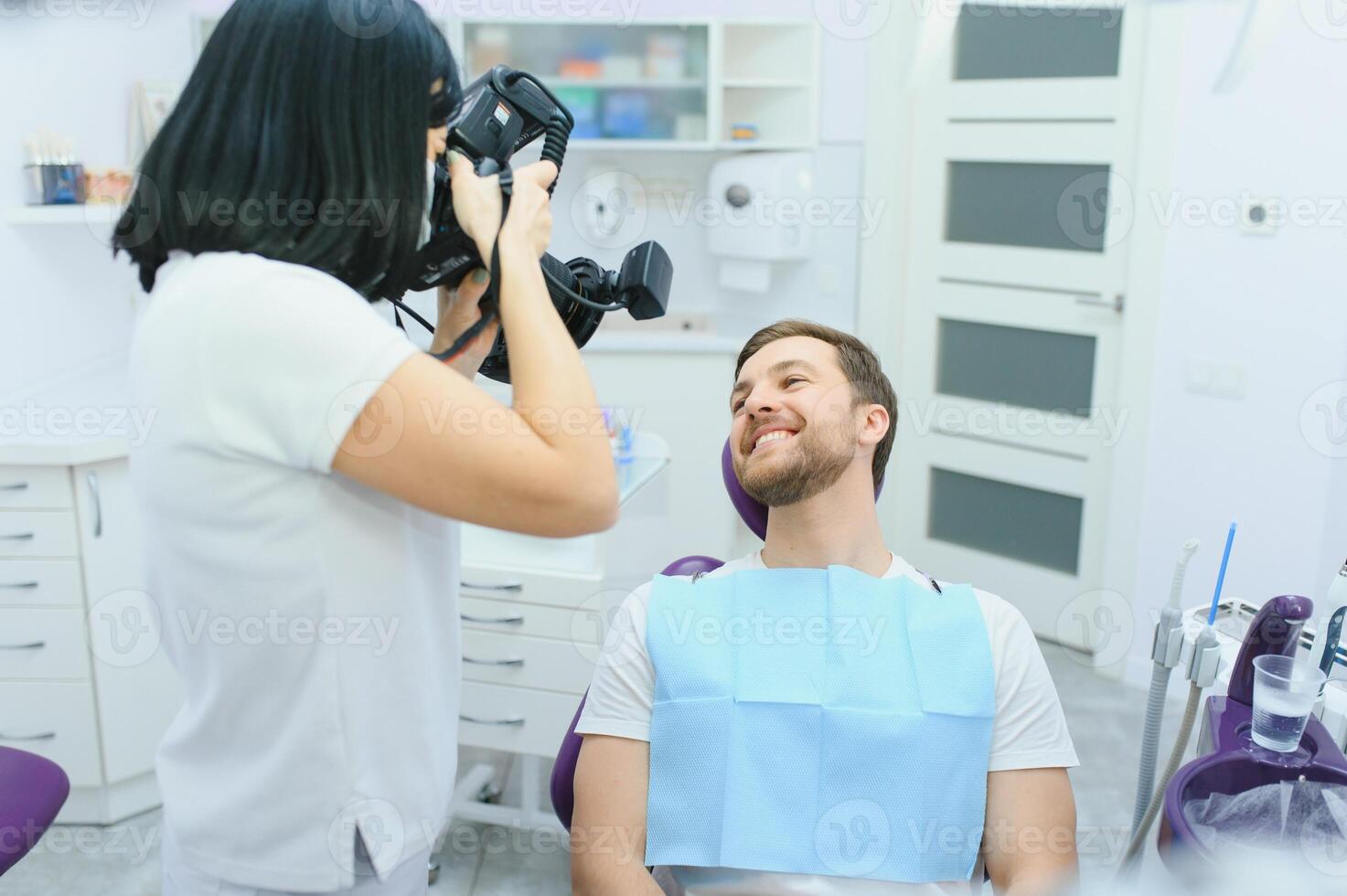 dentist clinic. A female dentist photographing her client's teeth during an appointment at the dental clinic. photo