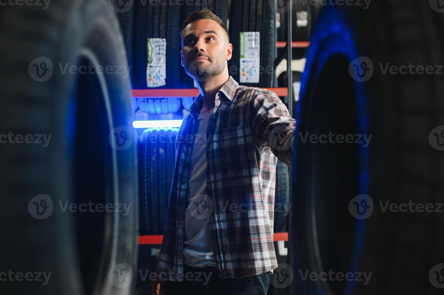 Man chooses winter car tires in the auto shop photo