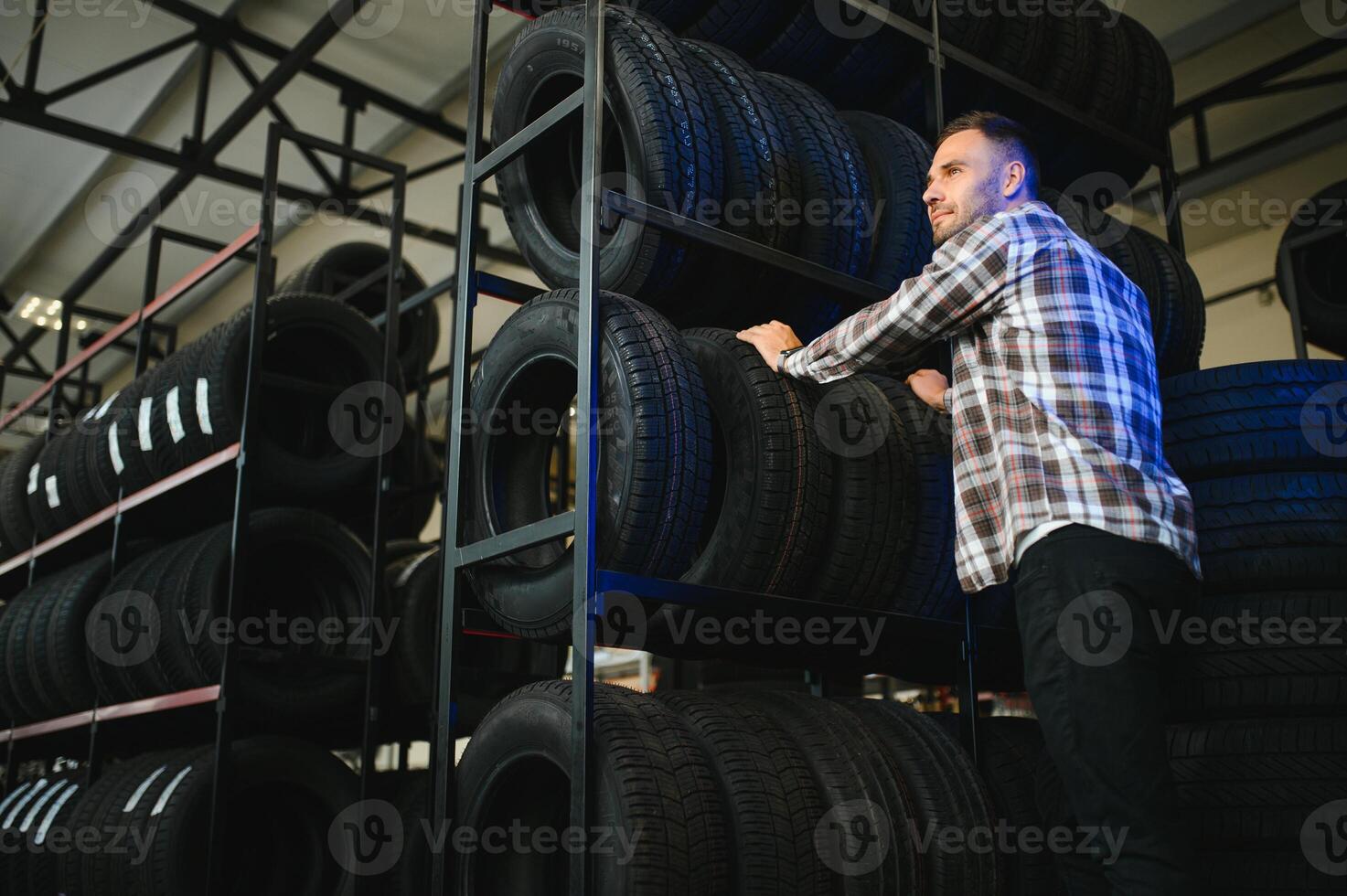 Man chooses winter car tires in the auto shop photo