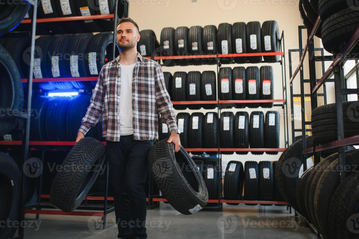 Man chooses winter car tires in the auto shop photo