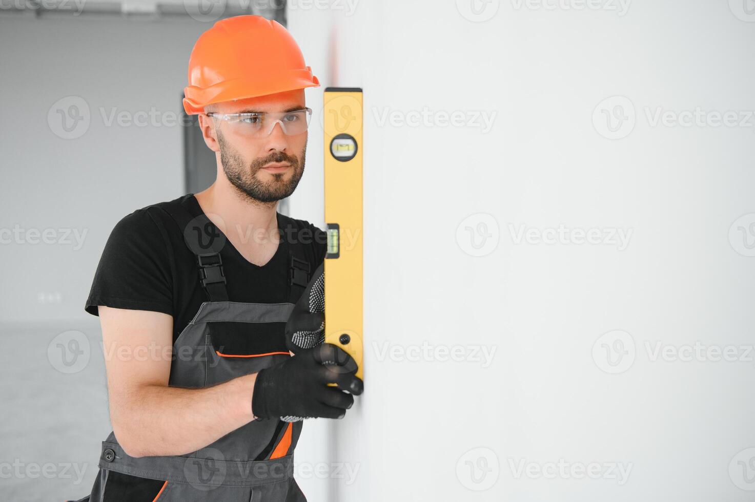 Construction Worker in uniform with spirit level photo