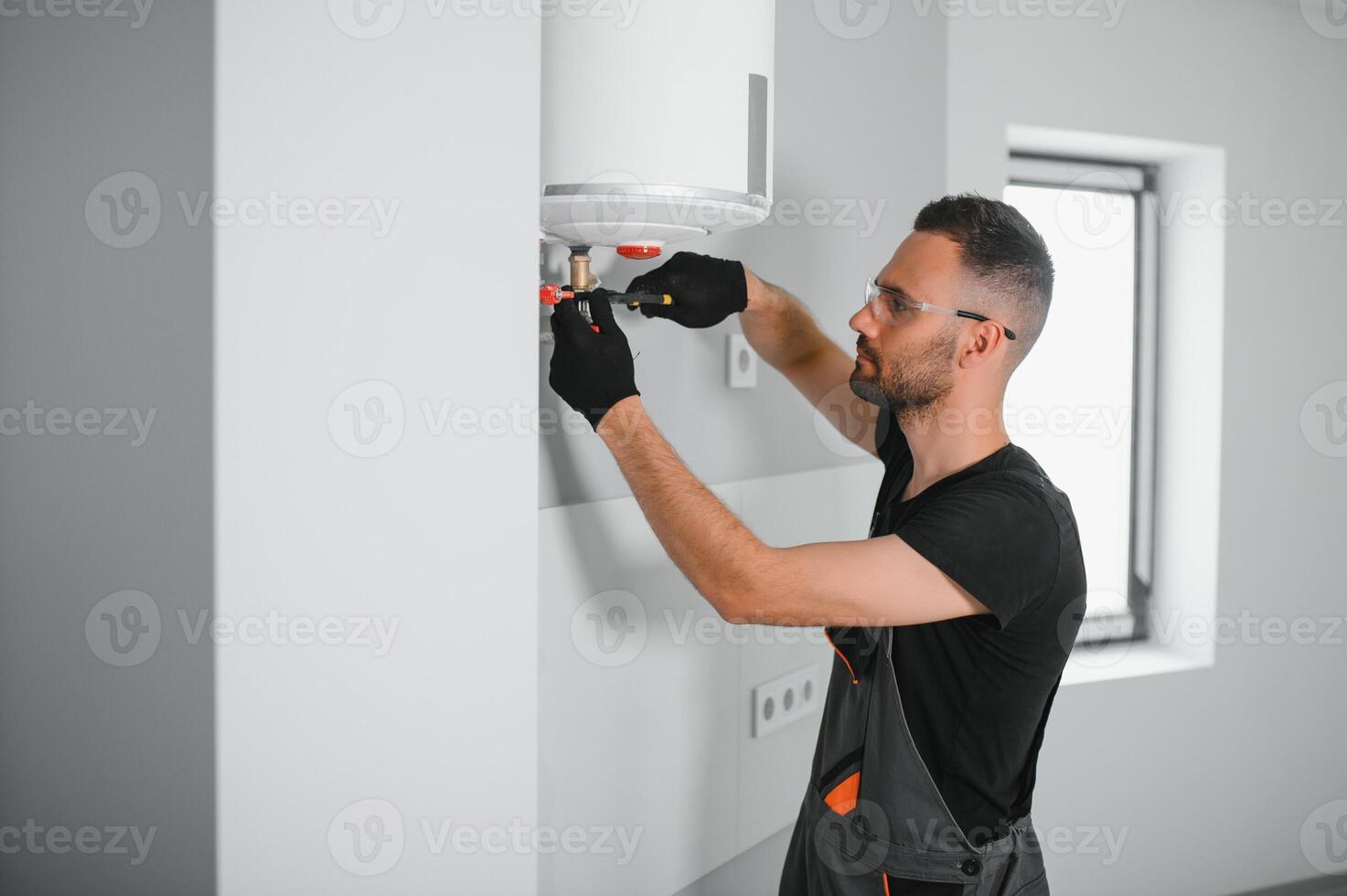 Professional plumber checking a boiler and pipes, boiler service concept photo