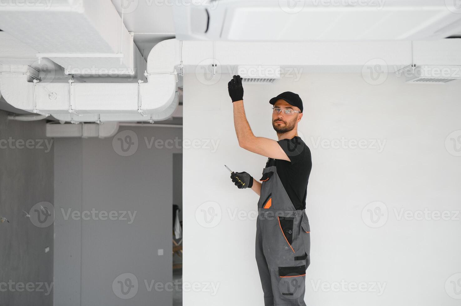 hvac technician at work. ventilation, heating system maintenance and repair photo