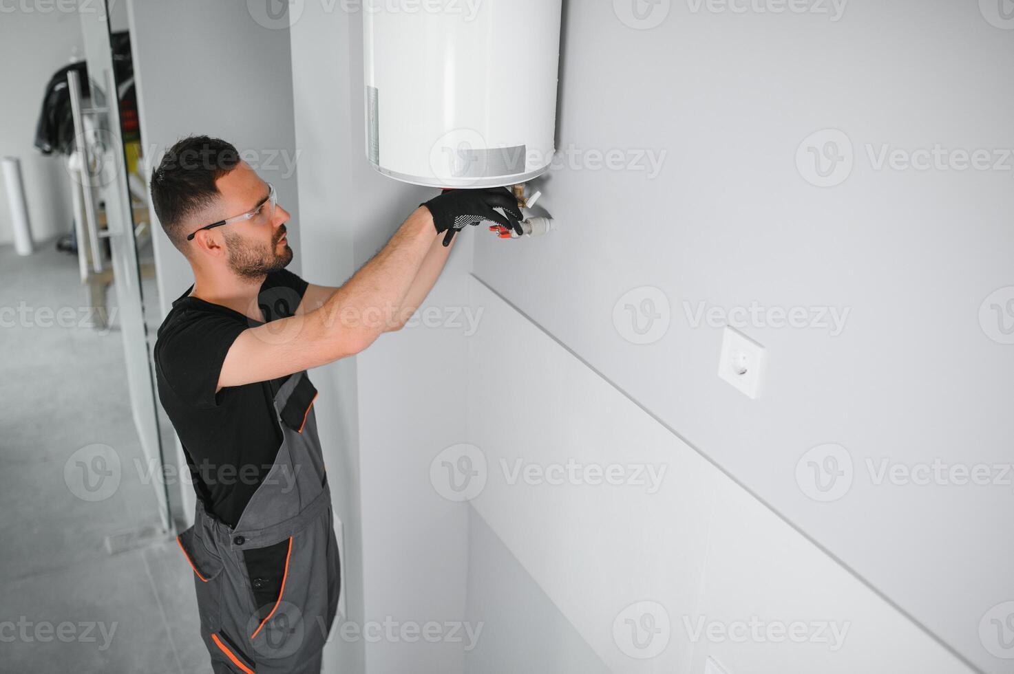 Professional plumber checking a boiler and pipes, boiler service concept photo